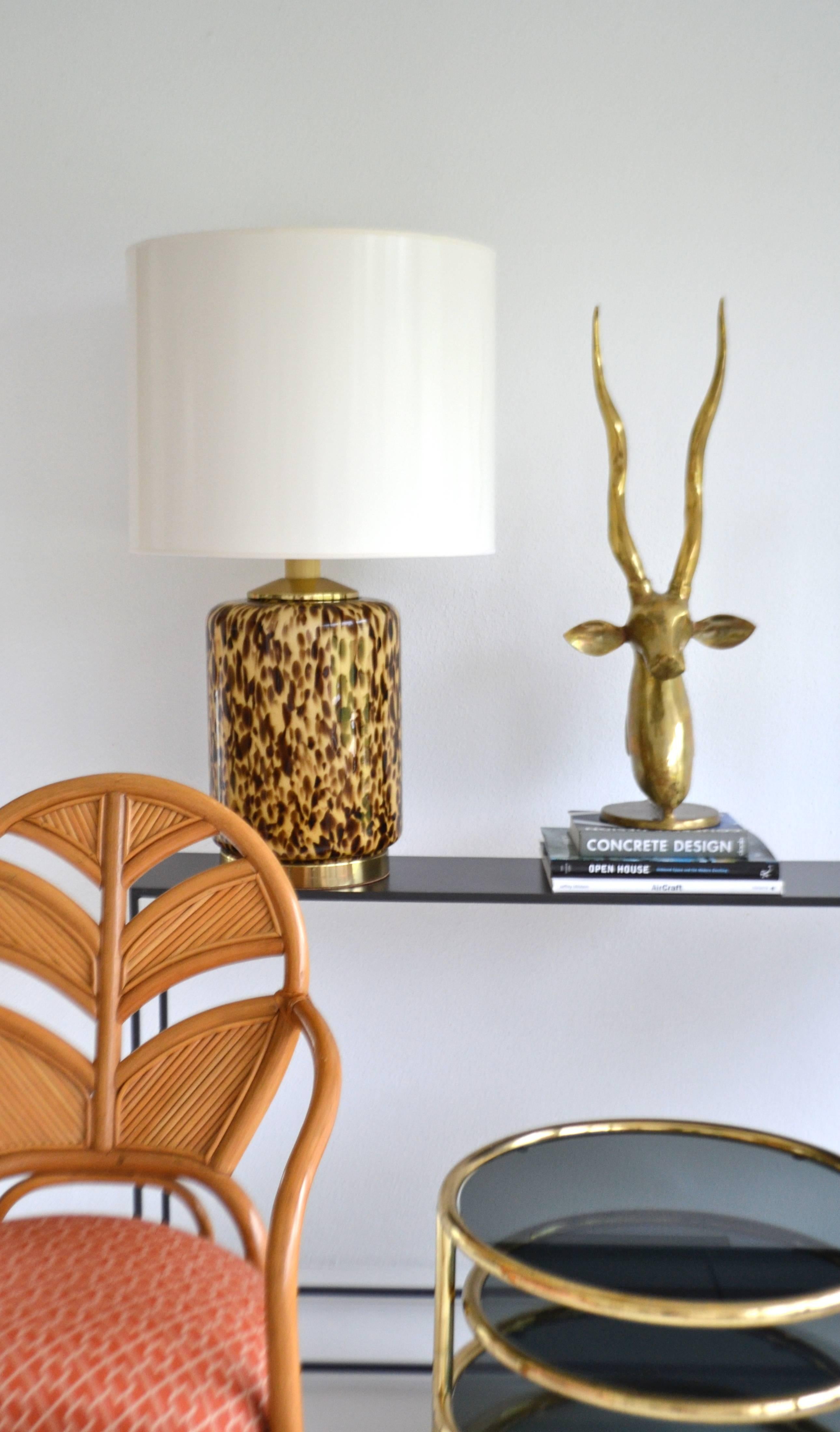 Glamorous midcentury Italian glass table lamps, circa 1960s-1970s. This stunning leopard pattern blown glass lamp is mounted on a brass base. 
Shade not included.
Measurements:
Overall: 34
