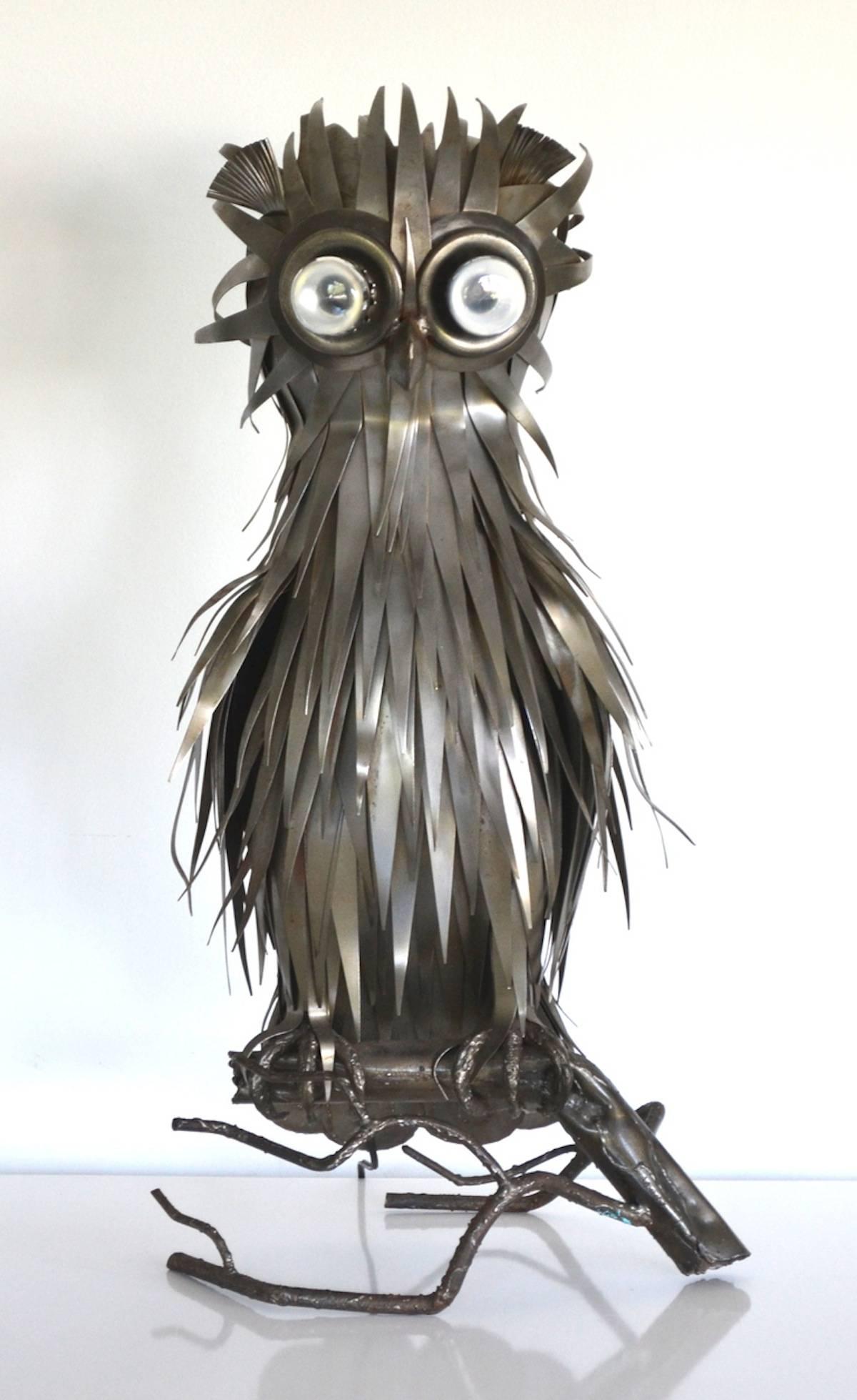 Sculptural midcentury Brutalist artisan crafted torch cut owl form table lamp by Michel Jarry, circa 1960s-1970s. This French Industrial lamp of hand-cut metal features two light sockets as eyes.