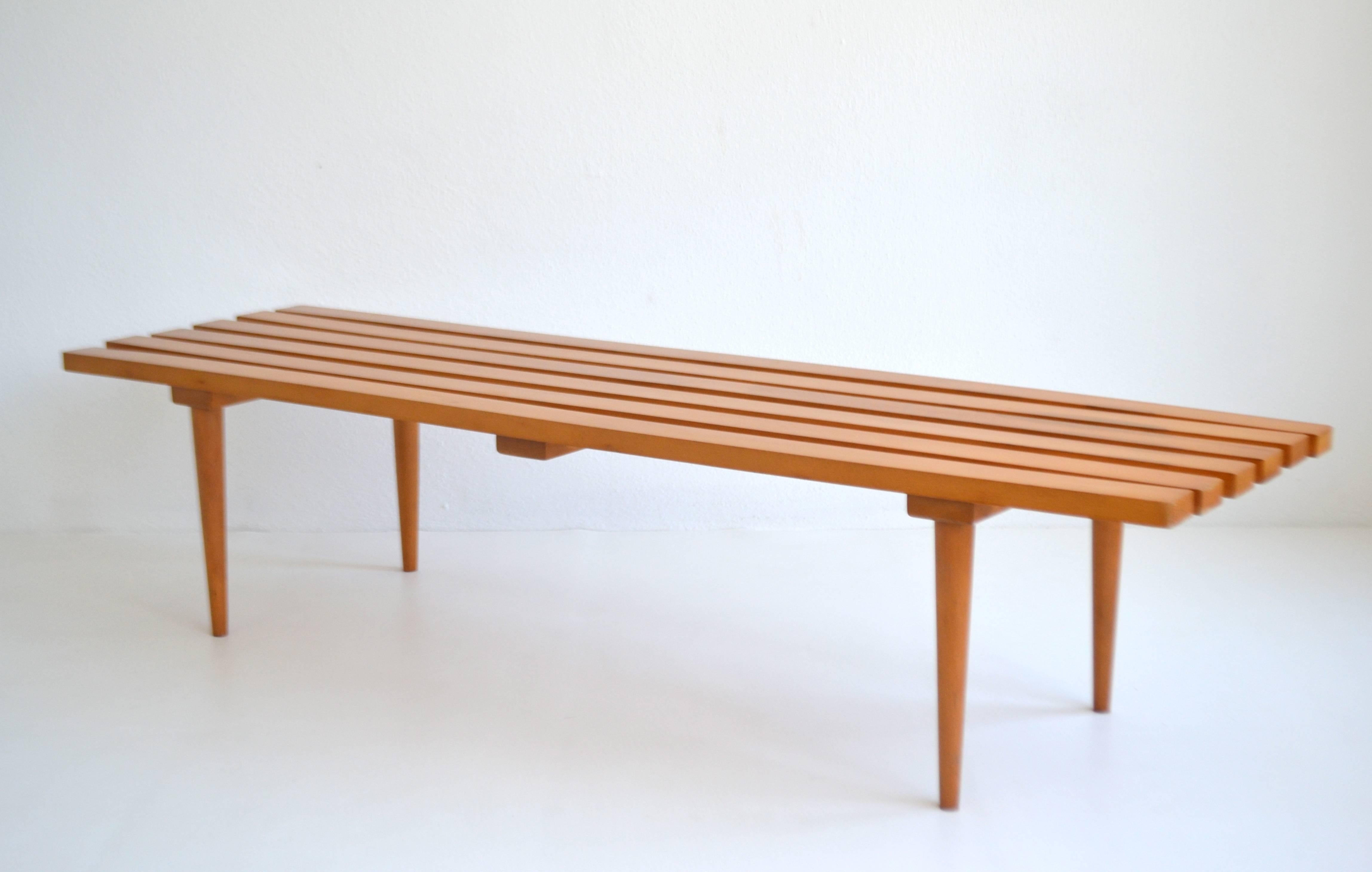Striking midcentury maple slat wood bench, circa 1960s-1970. The streamlined design allows this form to be versatilely used as a cocktail/ coffee table.