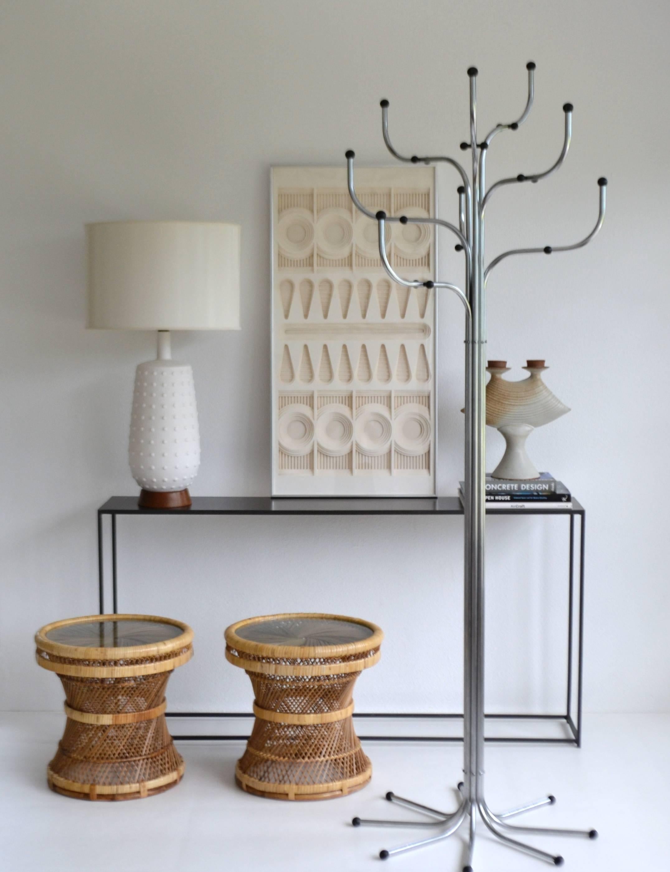 Striking pair of Mid-Century natural woven rattan drum occasional tables or side tables, circa 1960s-1970s. These incredible end tables or drinks tables are designed with intricately webbed rattan and outfitted with round inset glass tops.