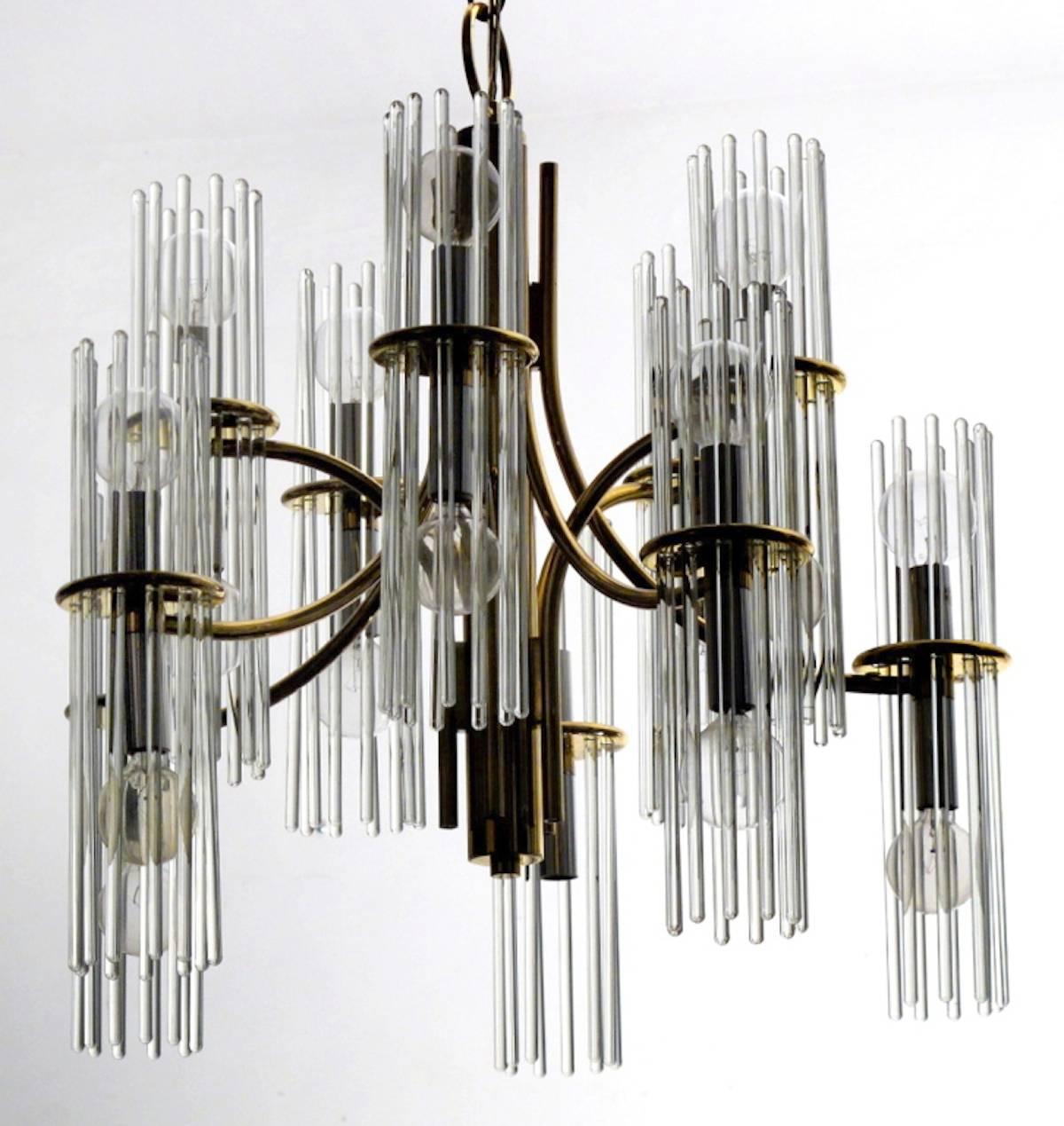 Glamorous Italian Mid-Century glass rod chandelier by Gaetano Sciolari for Lightolier, circa 1960s - 1970s. This sculptural chandelier is designed with 10 curving brass arms and 20 lights. It is in excellent pristine original condition.