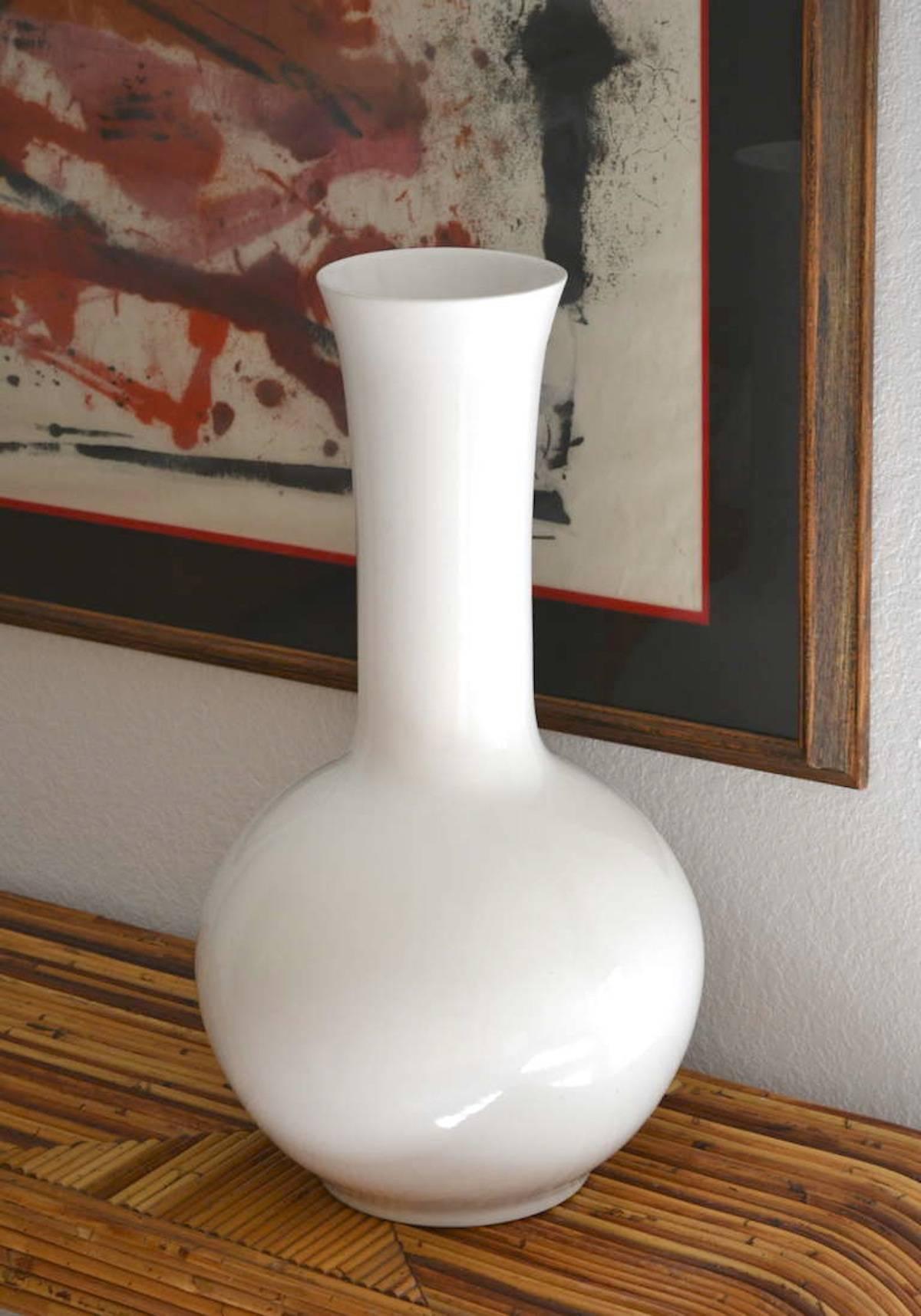 Stunning midcentury hand-turned Blanc de Chine long neck ceramic vase, circa 1950s-1960s. This white glazed vase is sculptural in form and highly decorative.