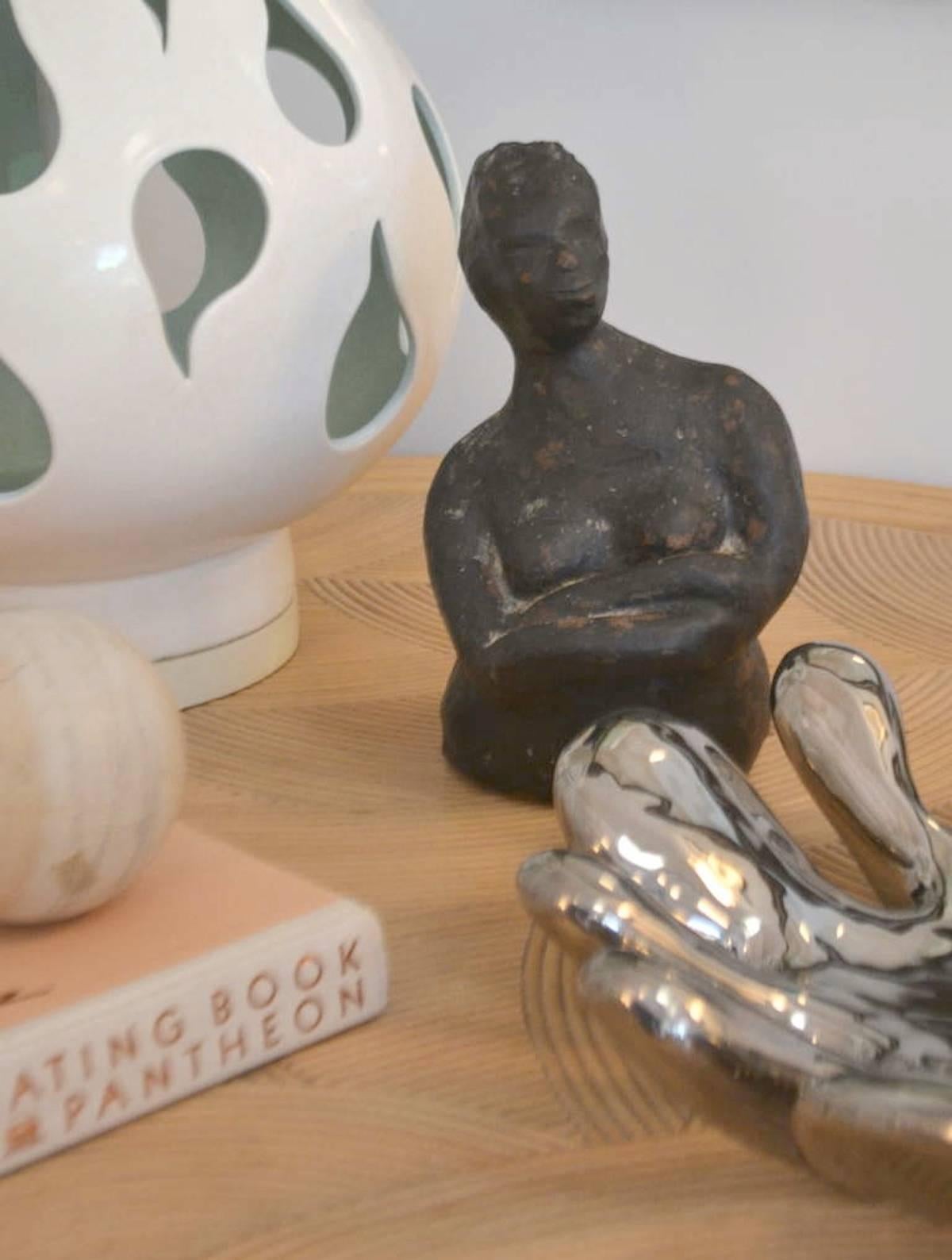 Striking hand thrown ceramic sculpture, circa 1950s-1960s. This midcentury sculpture of a female figure is organic in form with a subtle volcanic glaze.