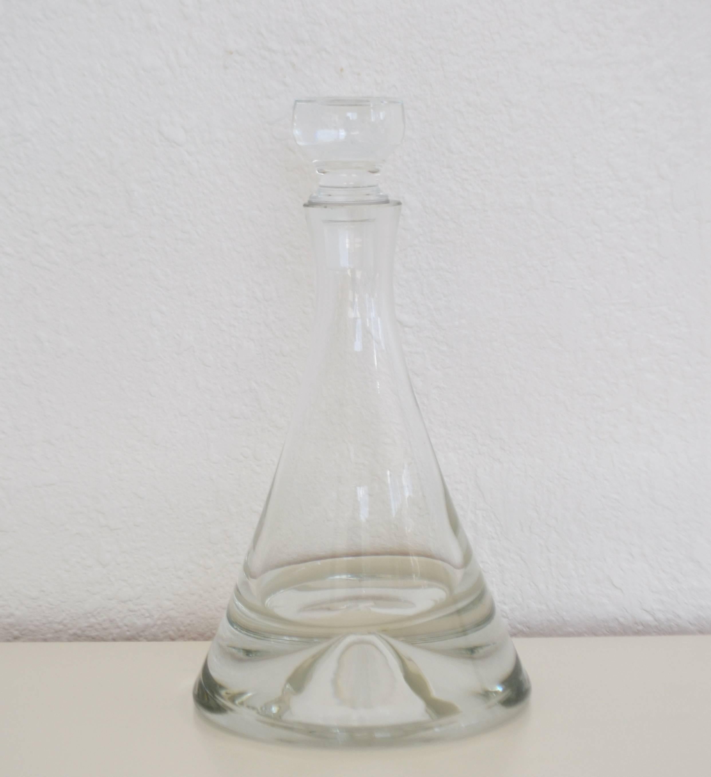 Spectacular Italian Mid-Century decanter, circa 1950s-1960s. This stunning thick clear blown glass decanter is sleekly designed and accented with a clear glass stopper.