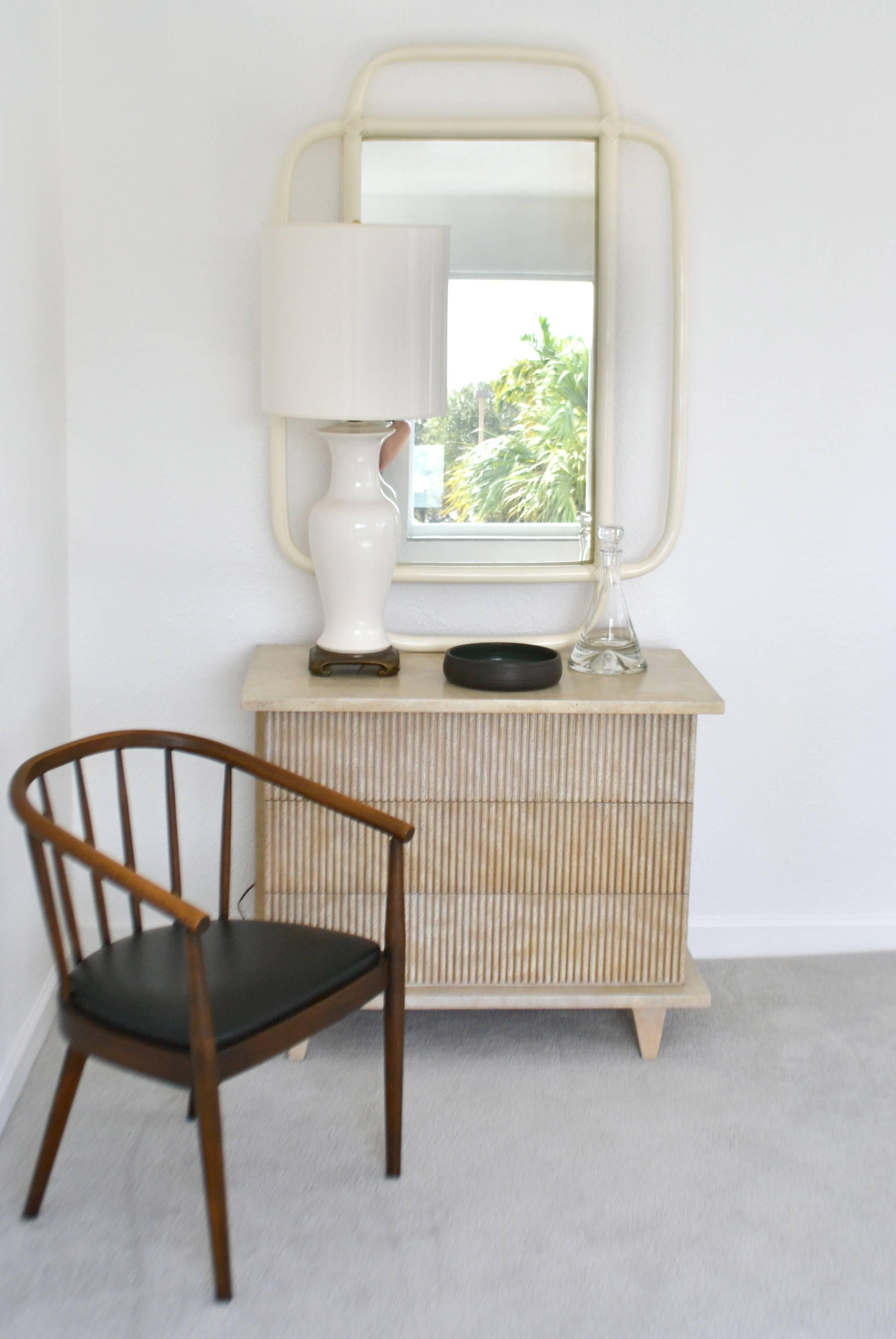 Glamorous Mid-Century bent bamboo wall mirror, circa 1960s. This sculptural artisan crafted mantel mirror is designed in a white lacquer finish and accented with rattan details. Measurements: The overall height is 52