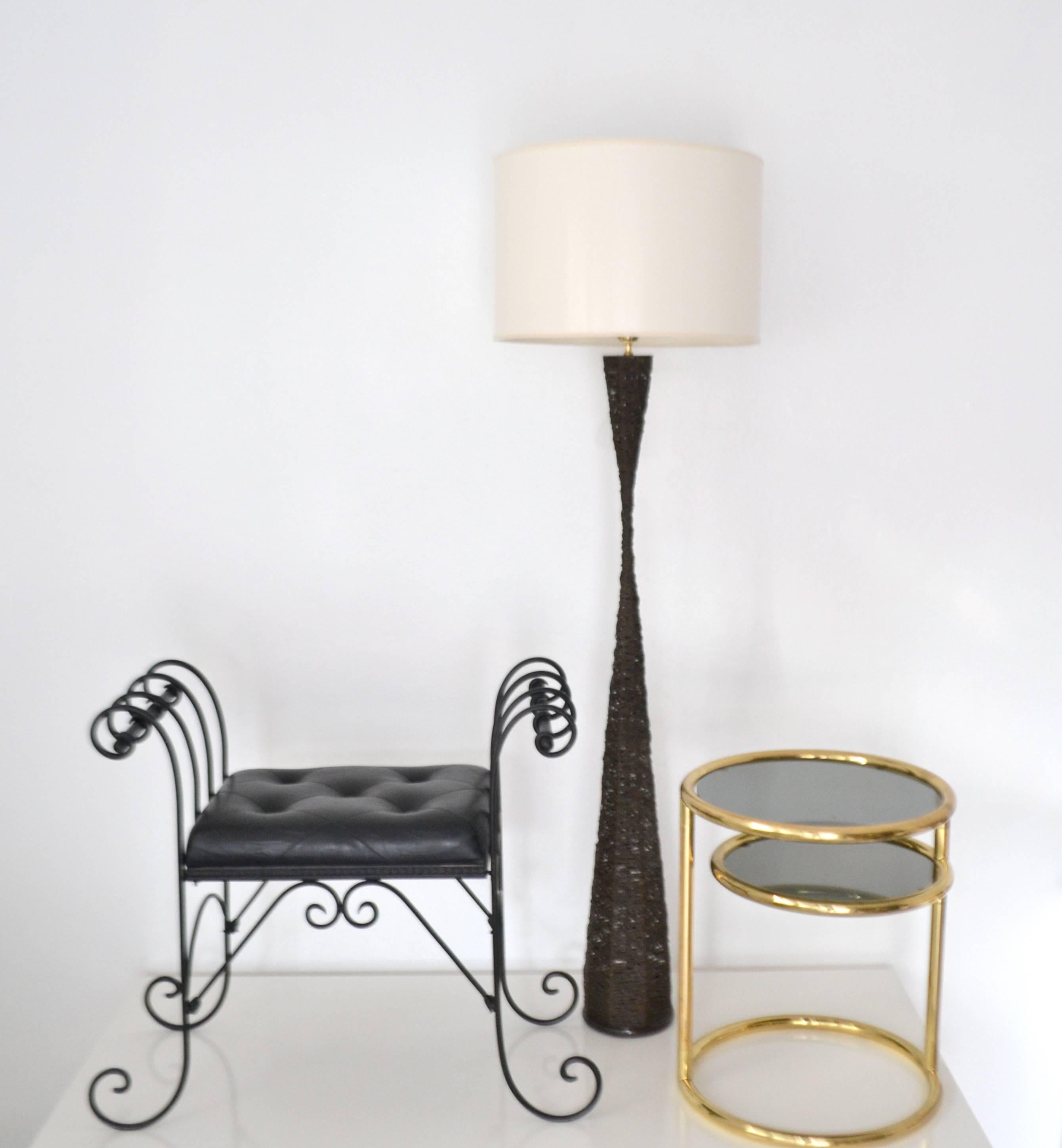 Striking Postmodern woven floor lamp, circa 1980s. This stunning sculptural standing lamp is artisan crafted of natural woven resin treated jute fibers and weighted with a hand-forged metal base. The lamp is wired with brass fittings. Shade not