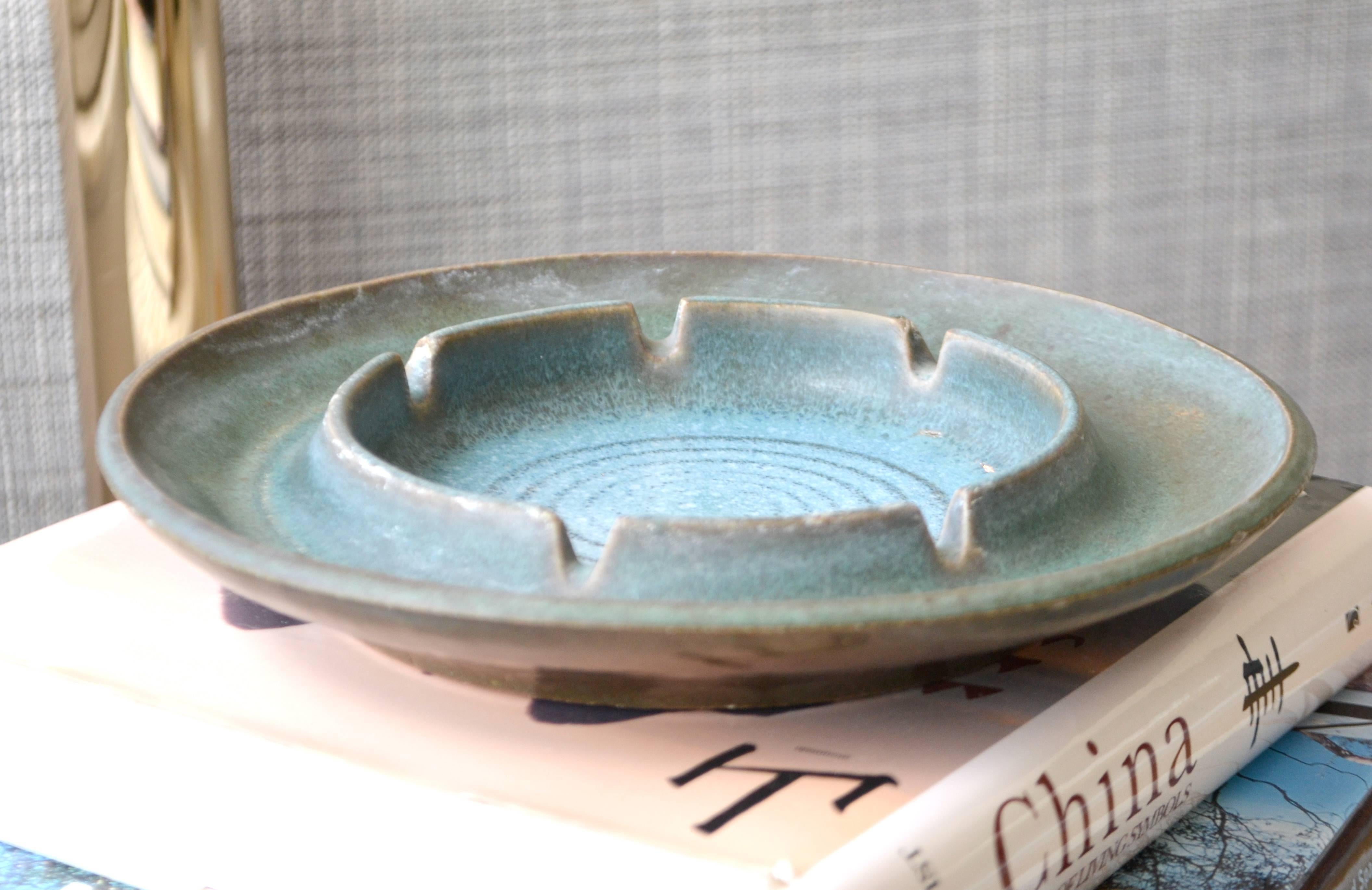 Striking Mid-Century ceramic ashtray by Robert Maxwell, circa 1960s. This sculptural tray is hand thrown and fired in soft muted glazes of blue tones and signed on the back.