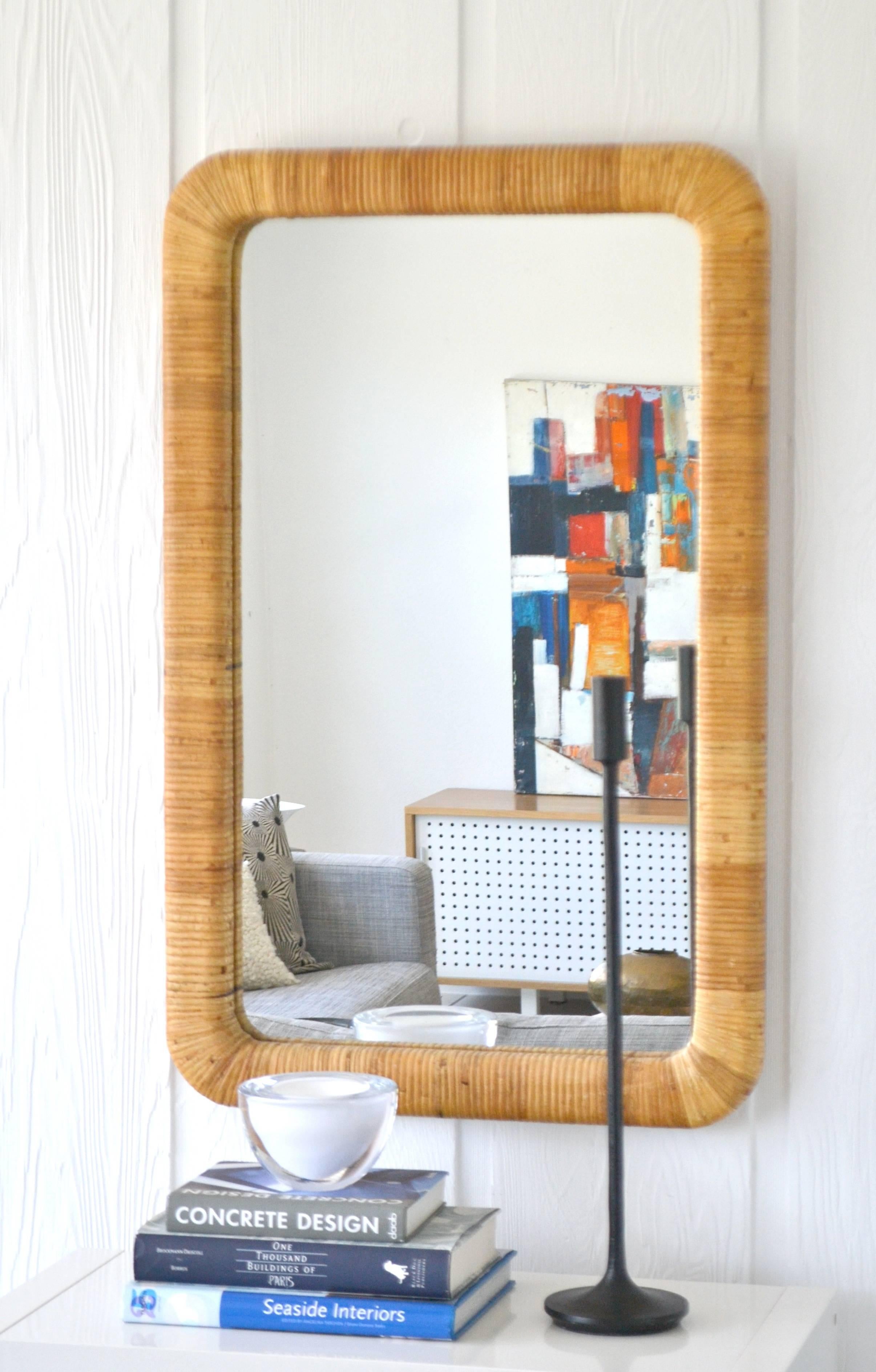 Striking pair of Mid-Century rattan wrapped rectangular form wall mirrors, circa 1960s. Measurements: 38.25 