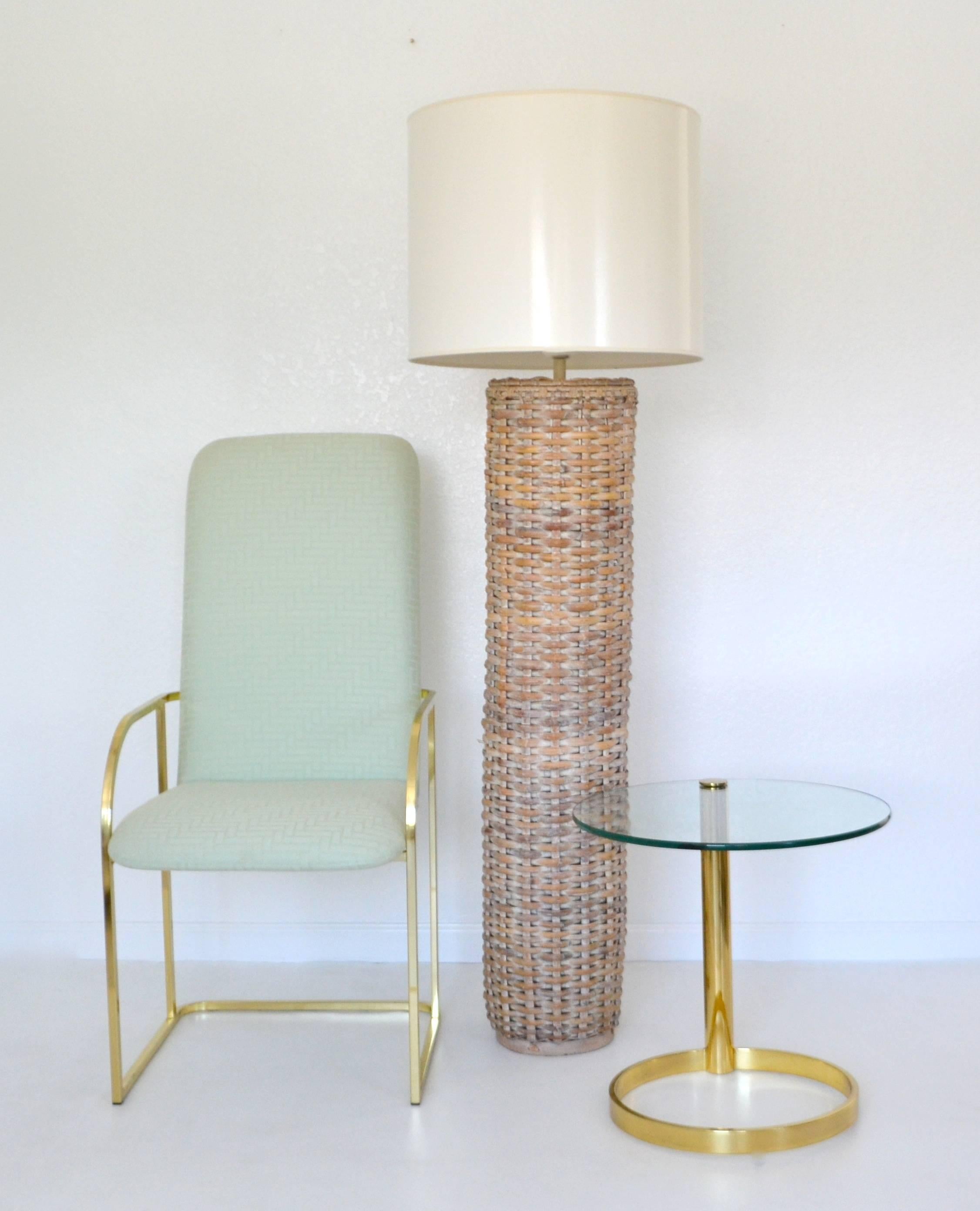 Striking midcentury woven rattan cylinder form floor lamp, circa 1960s. This sculptural artisan crafted standing lamp is wired with brass fittings. Shade not included. Measurements: 64