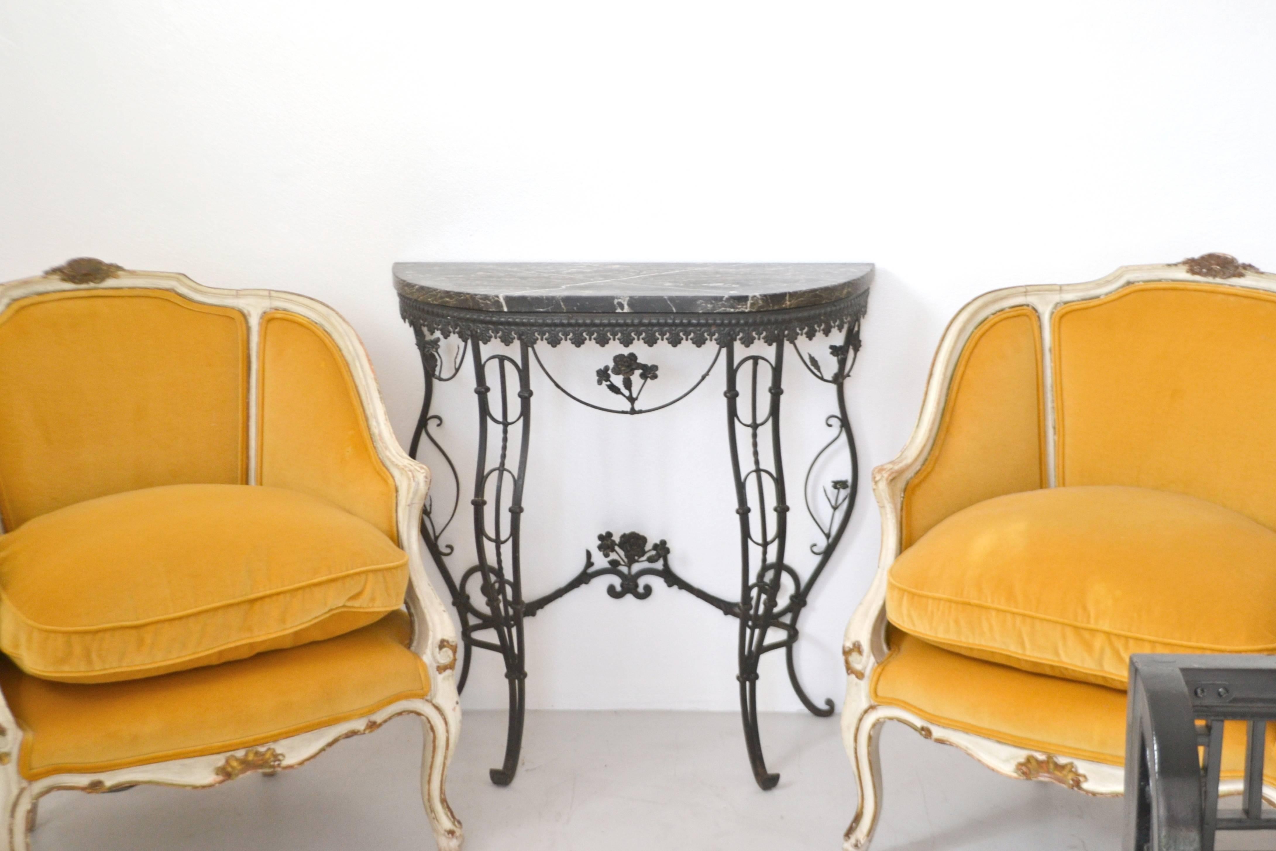 Stunning Hollywood Regency style Italian demilune console table, circa 1950s. This striking artisan crafted hall table is designed of blackened wrought iron with a marble top.