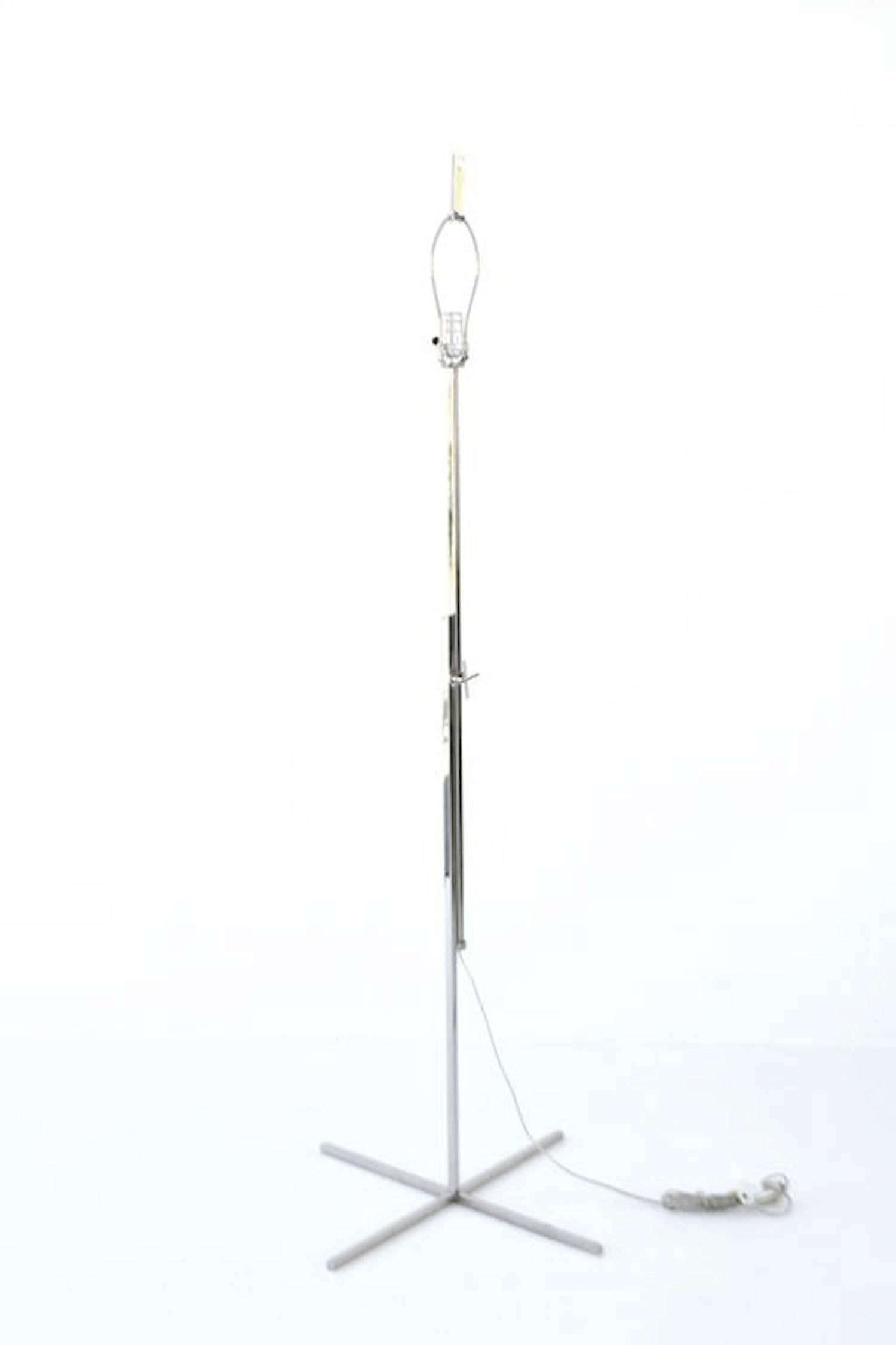 Striking Post-Modern adjustable height polished chrome cross base floor lamp, circa 1970s -1980s. This sculptural French custom crafted standing lamp is designed for adjustable heights. 
Shade not included.
Measurements:
Overall: 59