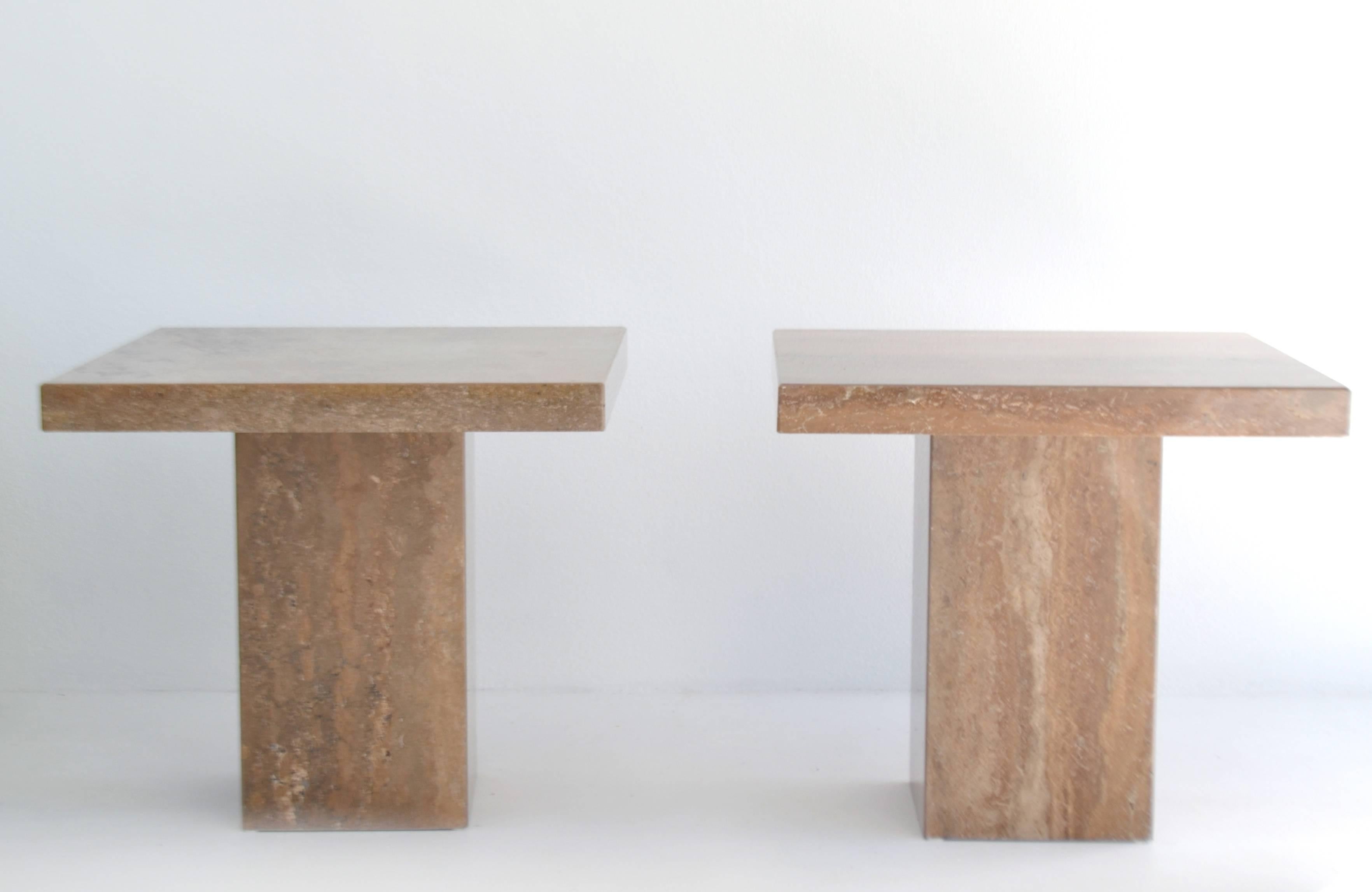 Pair of Italian Postmodern travertine side tables in the style of Willy Rizzo, circa 1970s-1980s. These striking square top travertine marble end tables nightstands are mounted on travertine marble plinth bases.

Measurements:
Overall 24.75