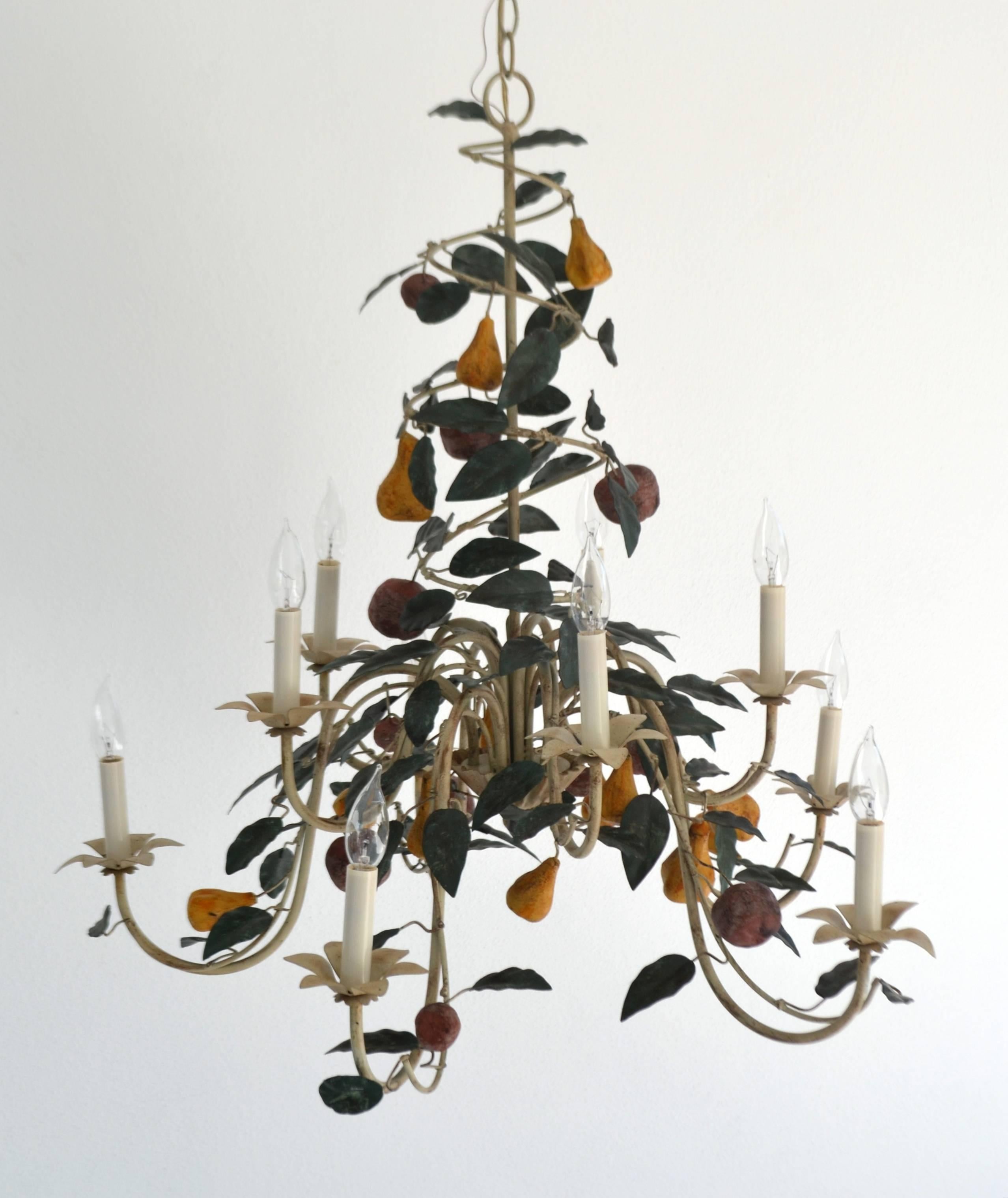 Striking Hollywood Regency tole ten-arm chandelier, circa 1960s. This stunning Italian custom-made chandelier is designed of painted tole foliage and fruit and accented with tole painted shades.
Measurements: 
Form: 32