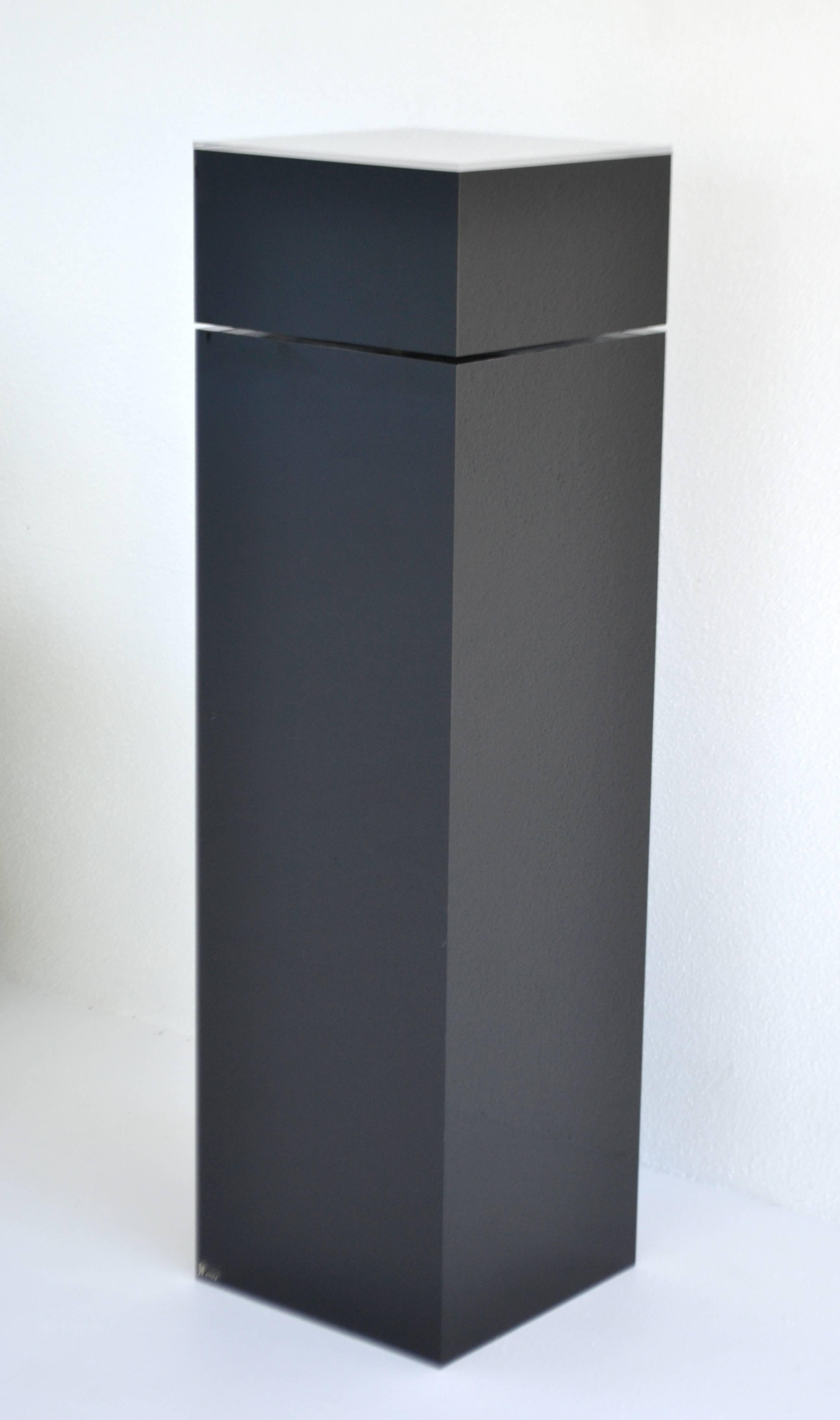 Sculptural Postmodern custom handmade black Lucite pedestal by Haziza, circa 1980s. The rotating top of this stunning pedestal is illuminated by an interior light fixture which creates uplighting.