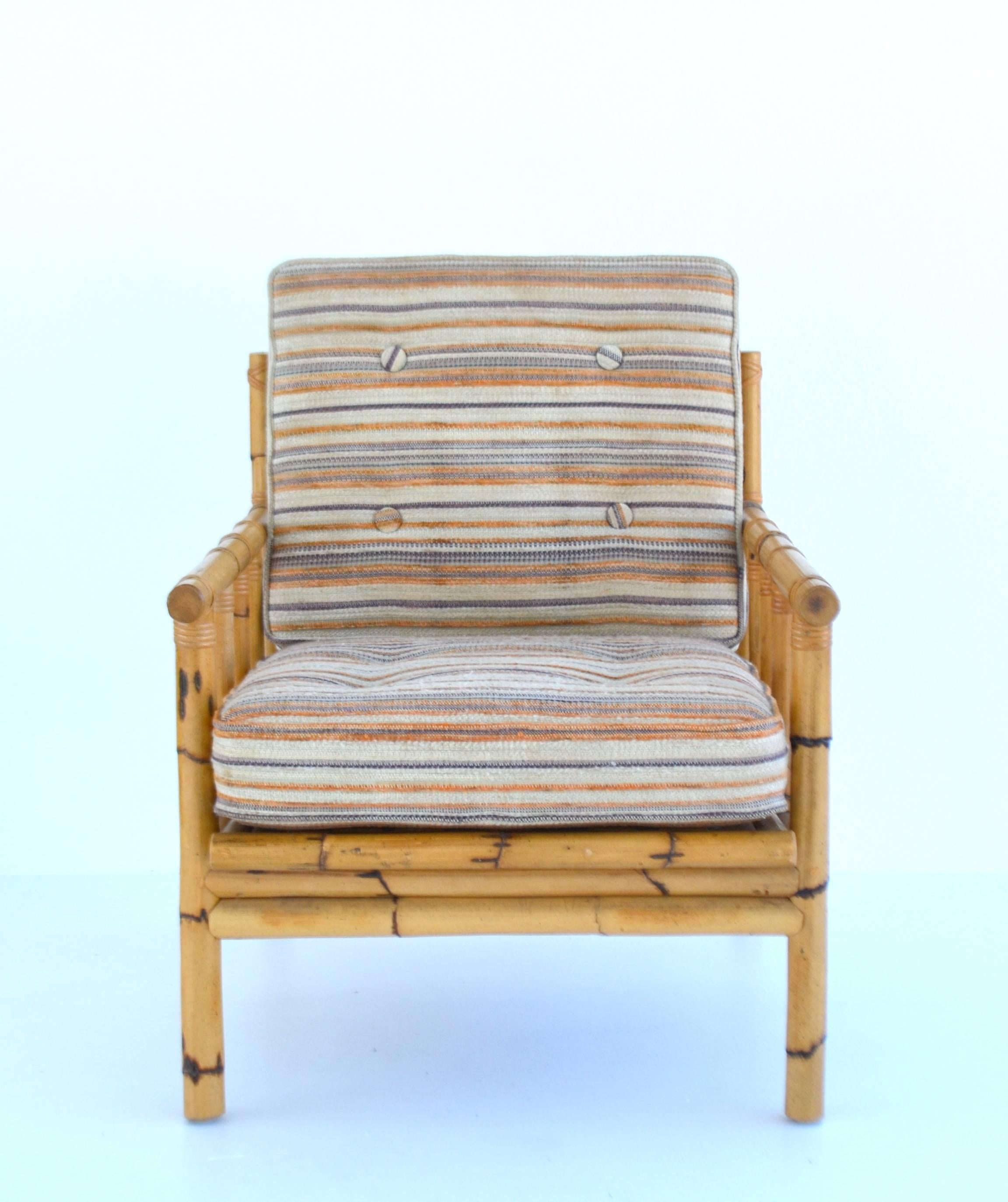 Striking midcentury bamboo framed club chair, circa 1950s-1960s. This custom lounge chair is upholstered with seat and back cushions in a cotton linen striped button-tufted fabric.
Measures:
Overall 25.5