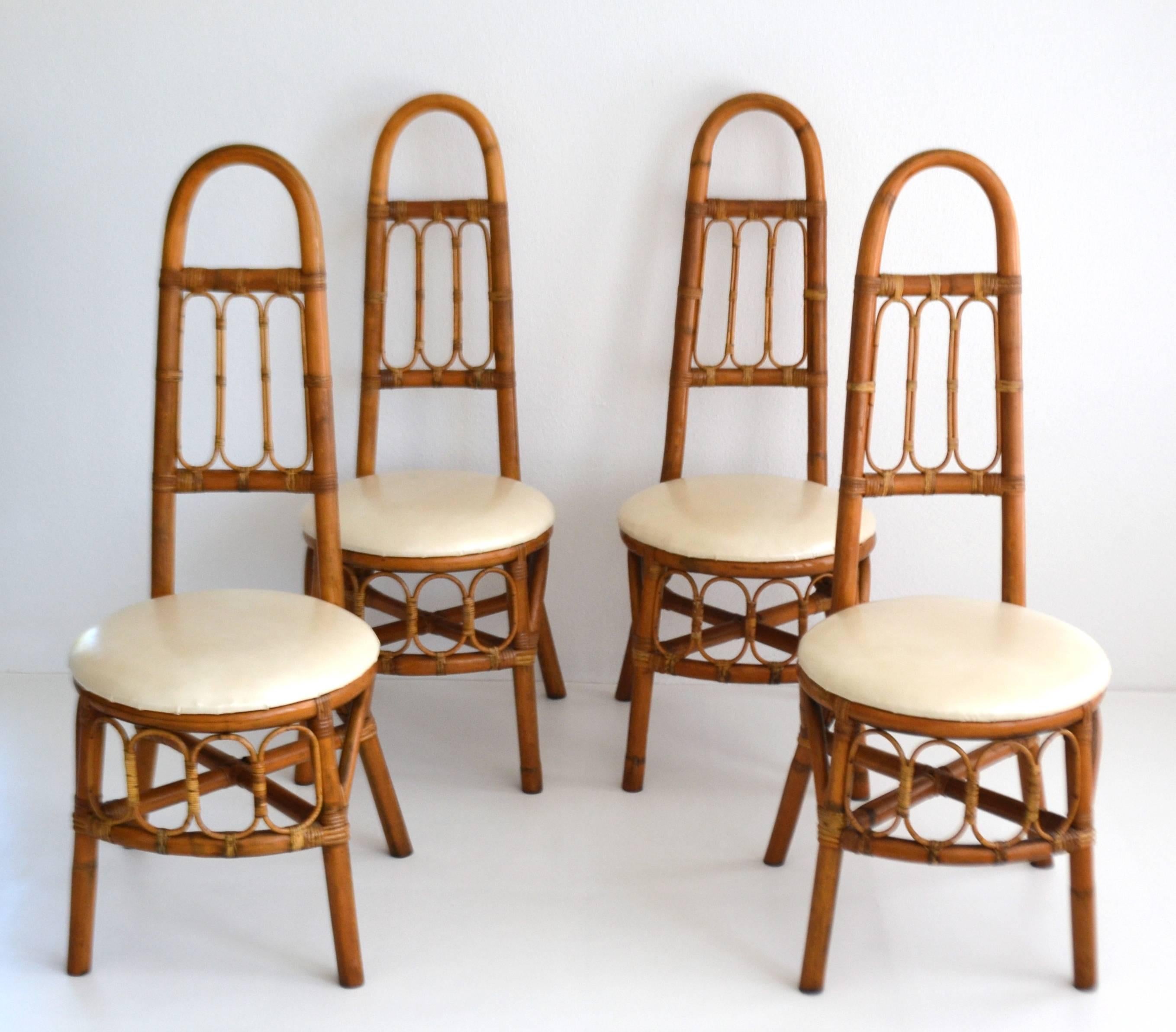 Striking set of four midcentury bent bamboo high back game table chairs, circa 1950s-1960s. These sculptural side chairs/hall chairs are in original excellent condition with a wonderful honey glazed aged patina.
