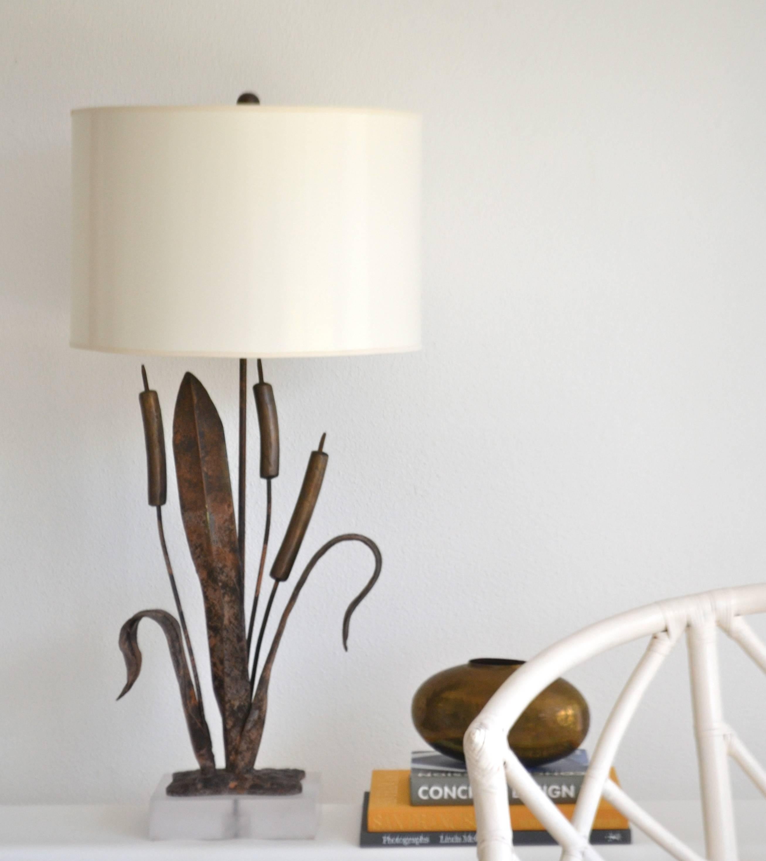 Striking Postmodern Brutalist inspired table Lamp, circa 1970s-1980s. This sculptural hand-wrought cattail form lamp is mounted on a Lucite base and wired with brass double cluster fittings.
Shade not included.
Measurements:
Overall: 36