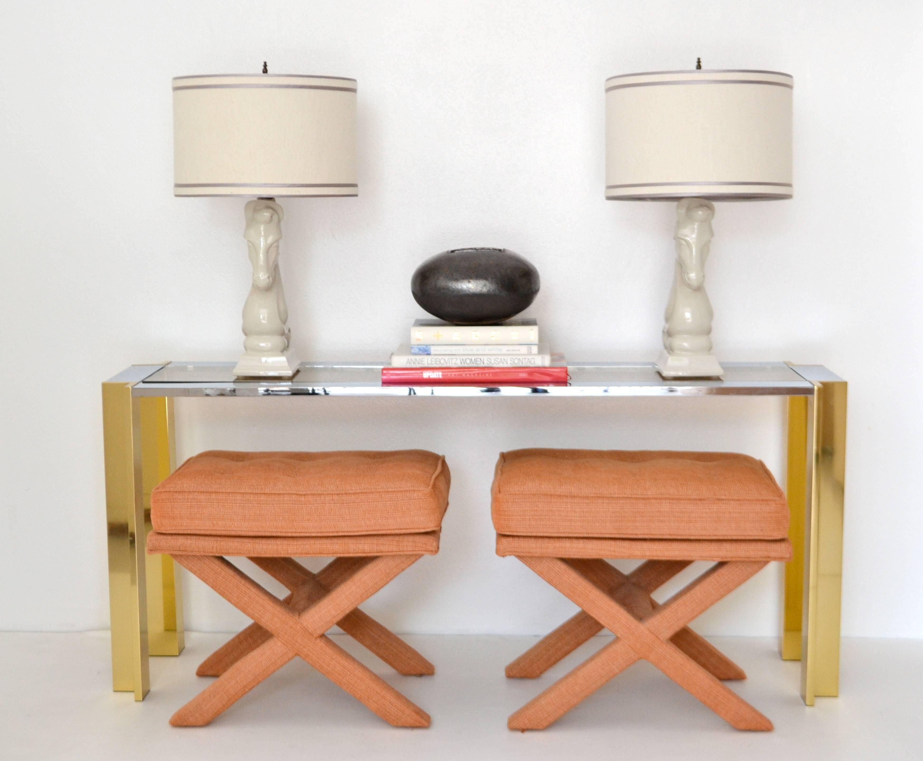 Glamorous pair of Mid-Century X-base button tufted stools, circa 1960s -1970s. These highly decorative benches are upholstered in a cotton linen nubby coral fabric.