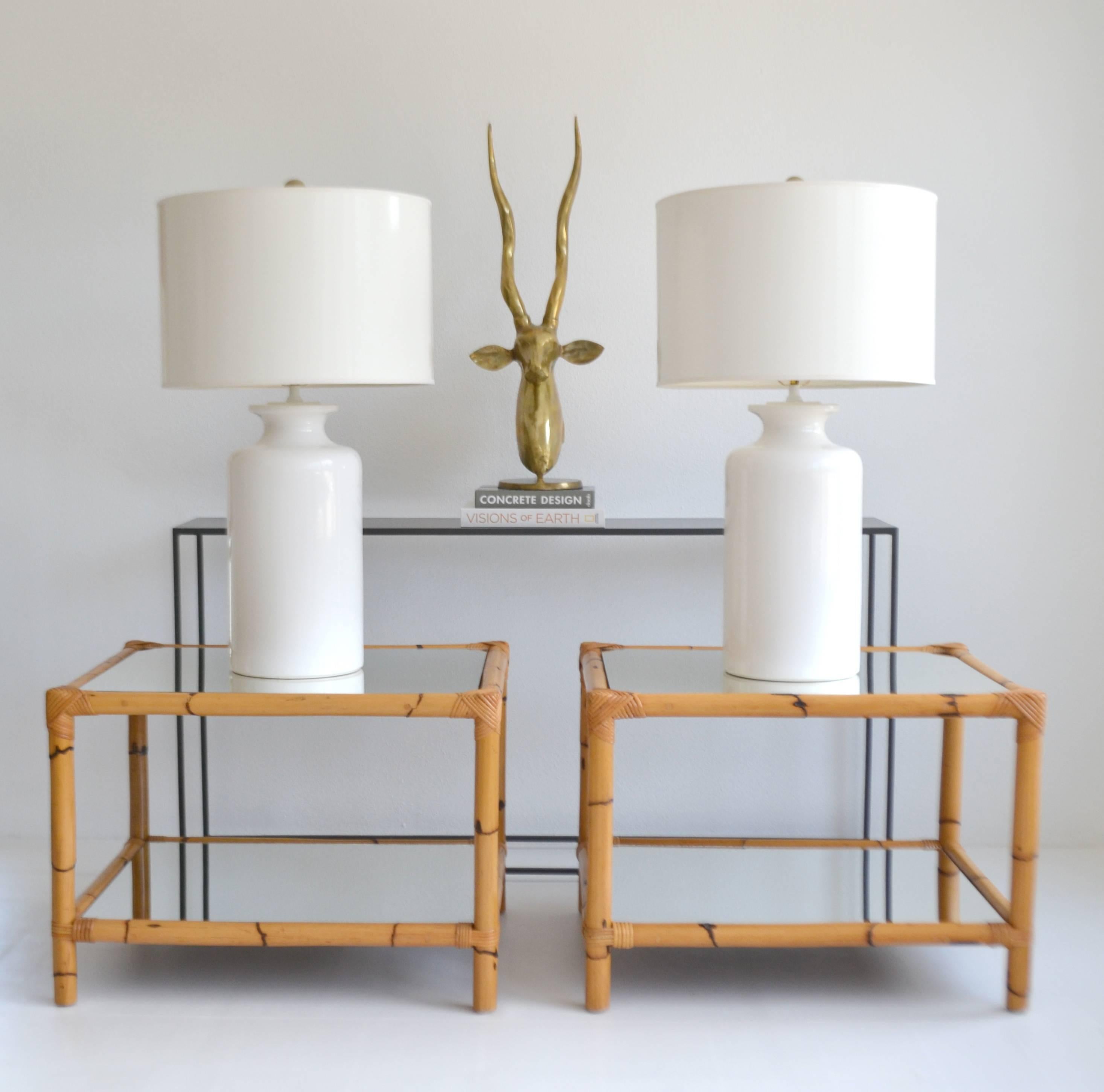 Striking pair of midcentury bamboo two-tier side tables with inset mirrored tops, circa 1960s-1970s.