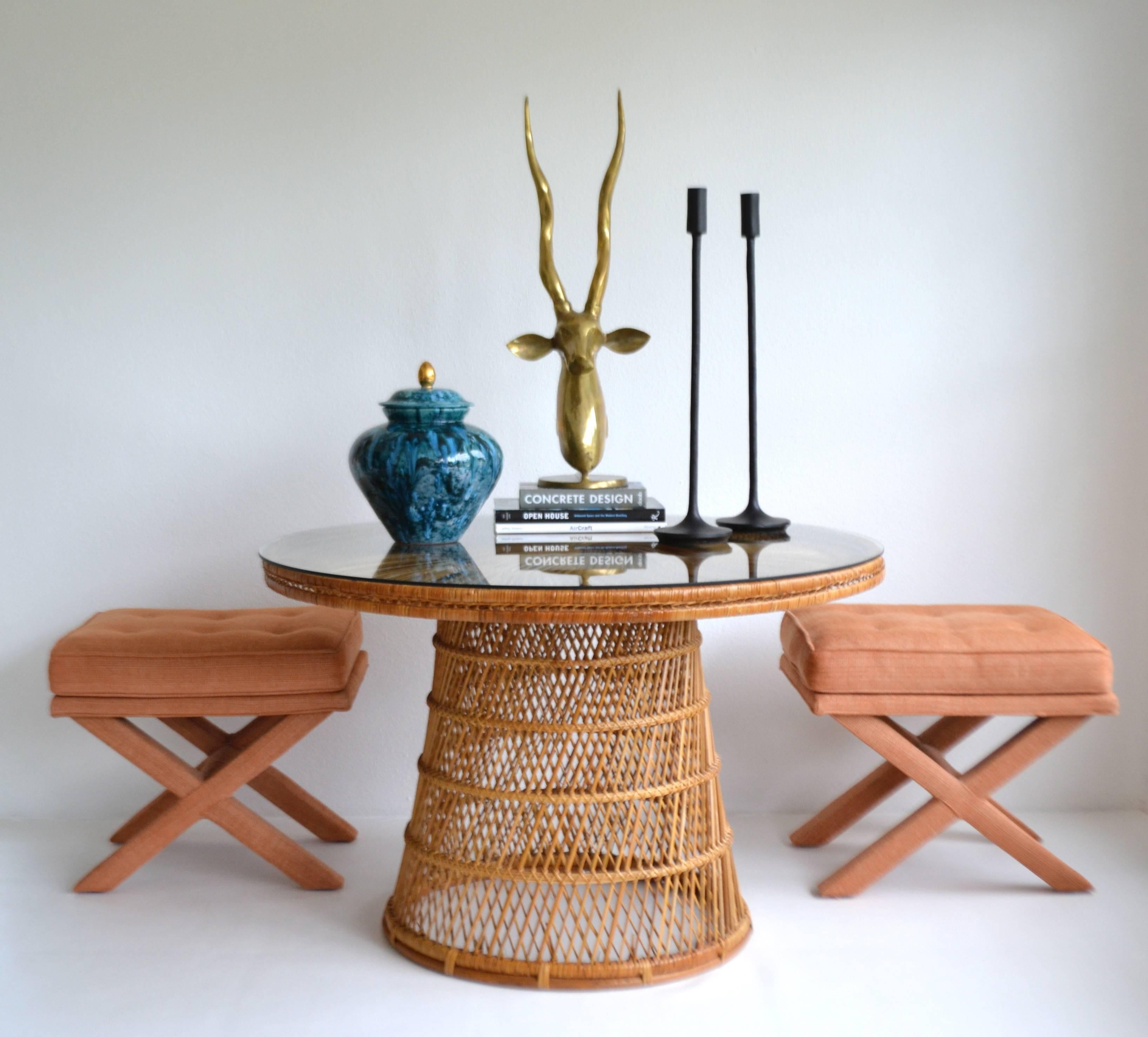 Striking Mid-Century woven rattan center hall table, circa 1960s -1970s. This striking game table is designed of an intricately webbed woven rattan pattern over a wooden frame and outfitted with a round glass top.
