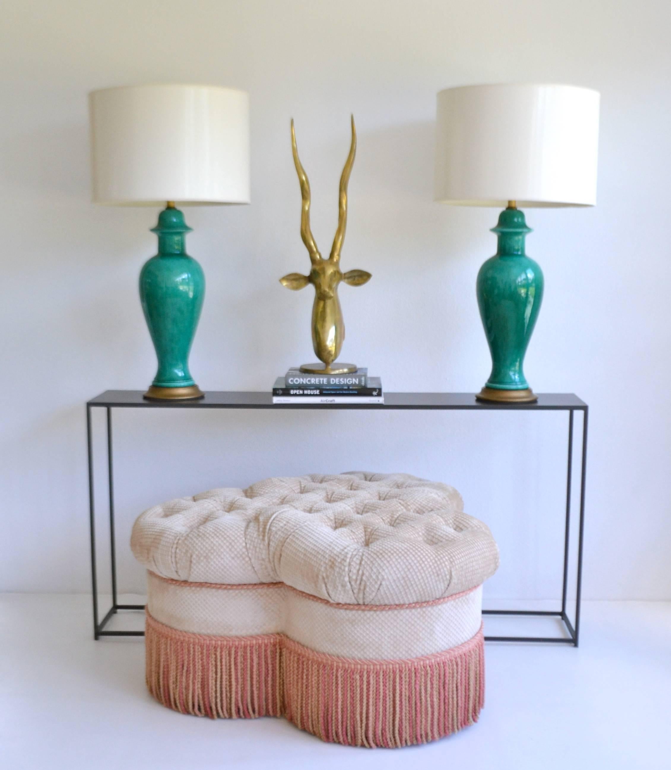 Glamorous Hollywood Regency style clover leaf form tufted ottoman, circa 1970s-1980s. This elegant large-scale custom crafted ottoman/ coffee table with a bullion fringe skirt is upholstered in an embossed cotton velvet fabric. Excellent condition.