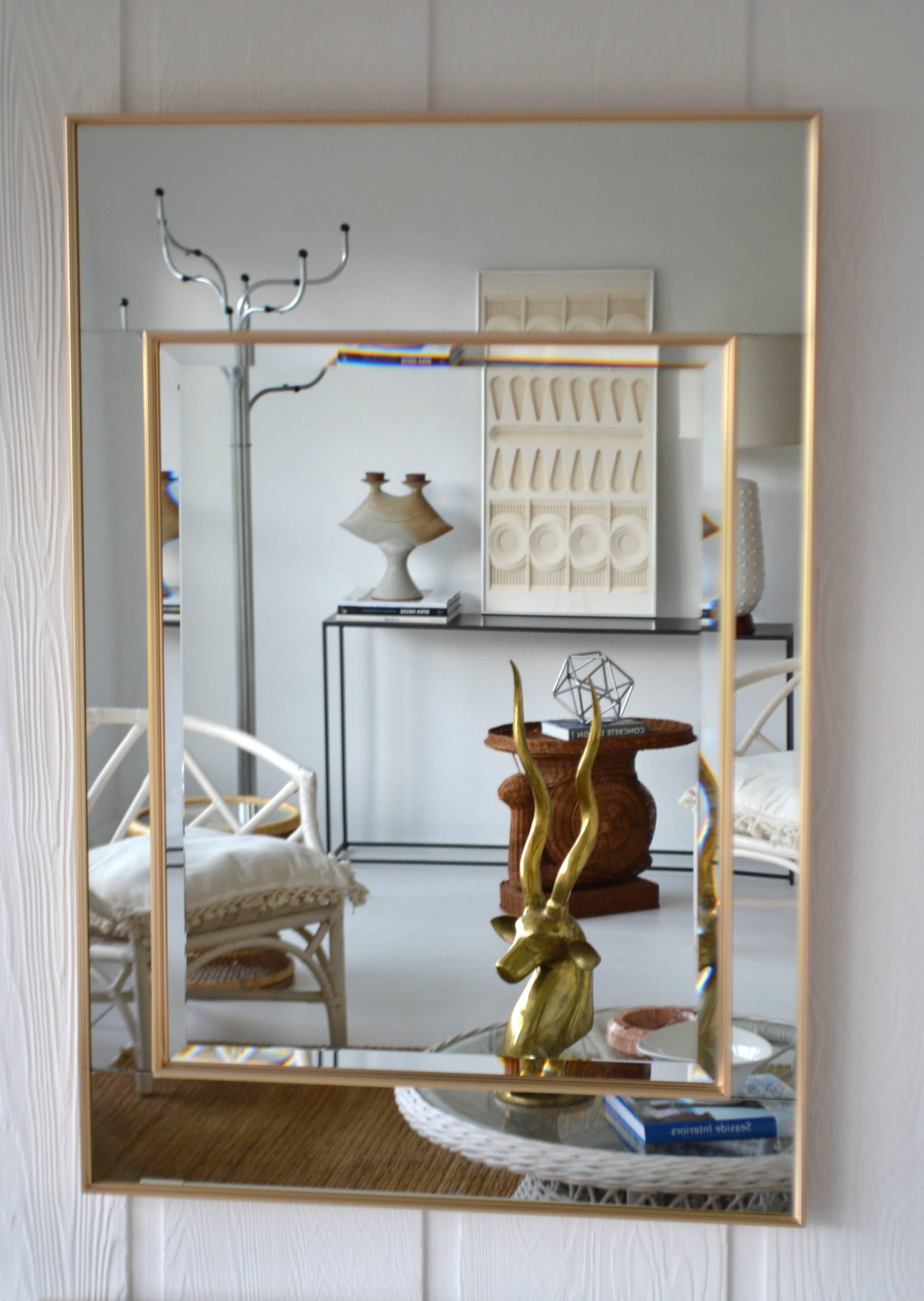Glamorous Hollywood Regency style wall mirror by La Barge, circa 1980s. This stunning large-scale mirror-framed mantel mirror is designed with mirrored panels encased in reeded brass frames surrounding an inset beveled mirror.