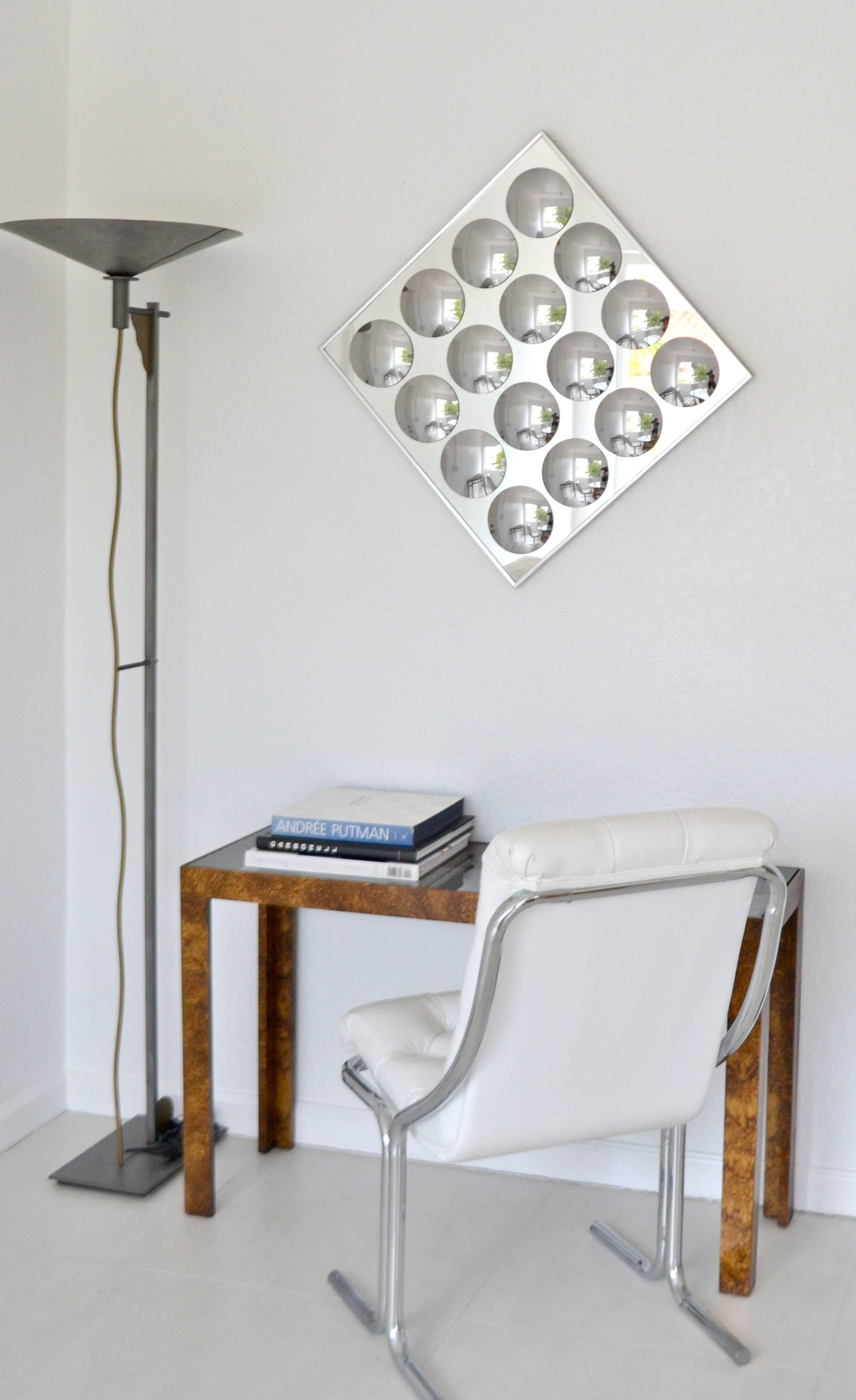 Striking midcentury Op Art wall mirror designed by Hal Bienenfeld, circa 1970s. This incredible artisan crafted mirror is designed of convex mirrors on a square mirror form and mounted in a polished chrome frame. Designed to be hung on a diagonal or