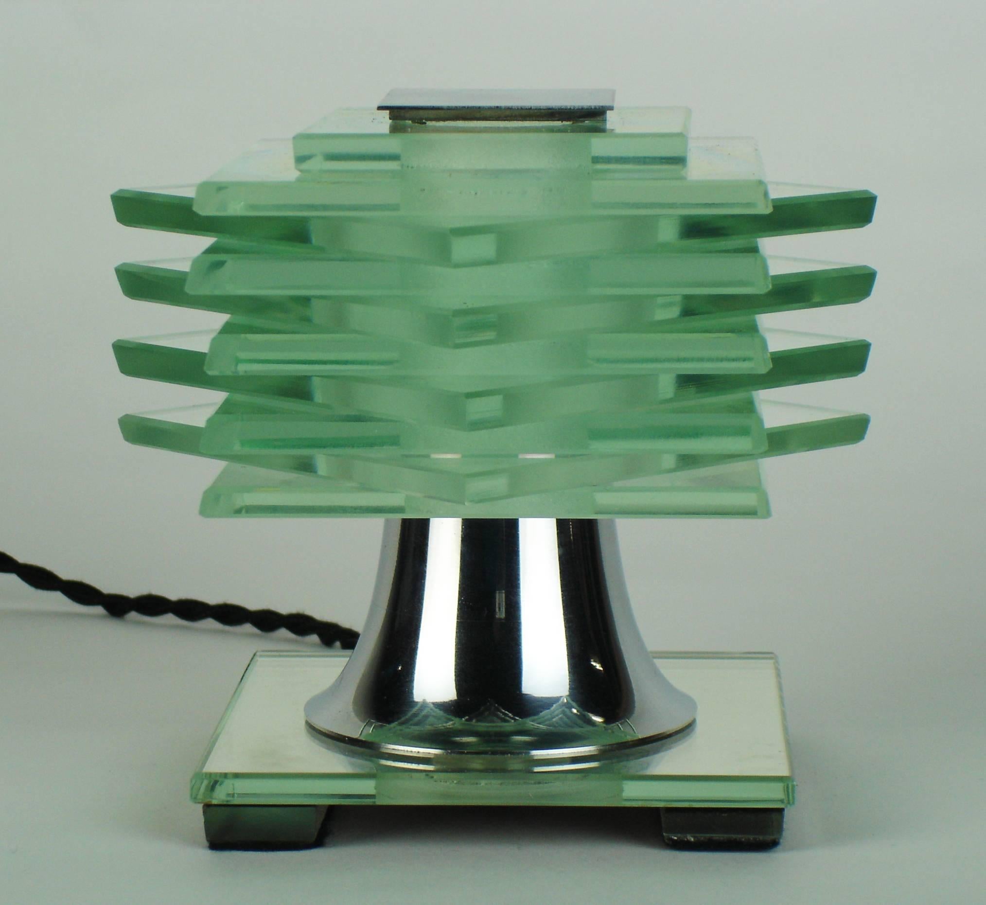 An Art Deco table lamp with ten thin glass plates held between a chromed brass stem and plate, a squared mirror plate support. This lamp is rewired with a small screw socket.
