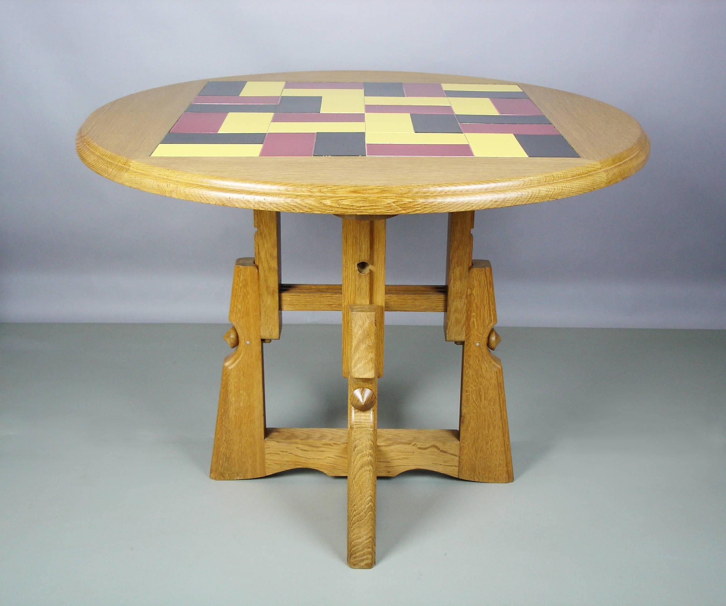 A solid oak table with red, yellow, black tiles fit in square into the top. Two adjustable heights:
20in or 28.25in.
