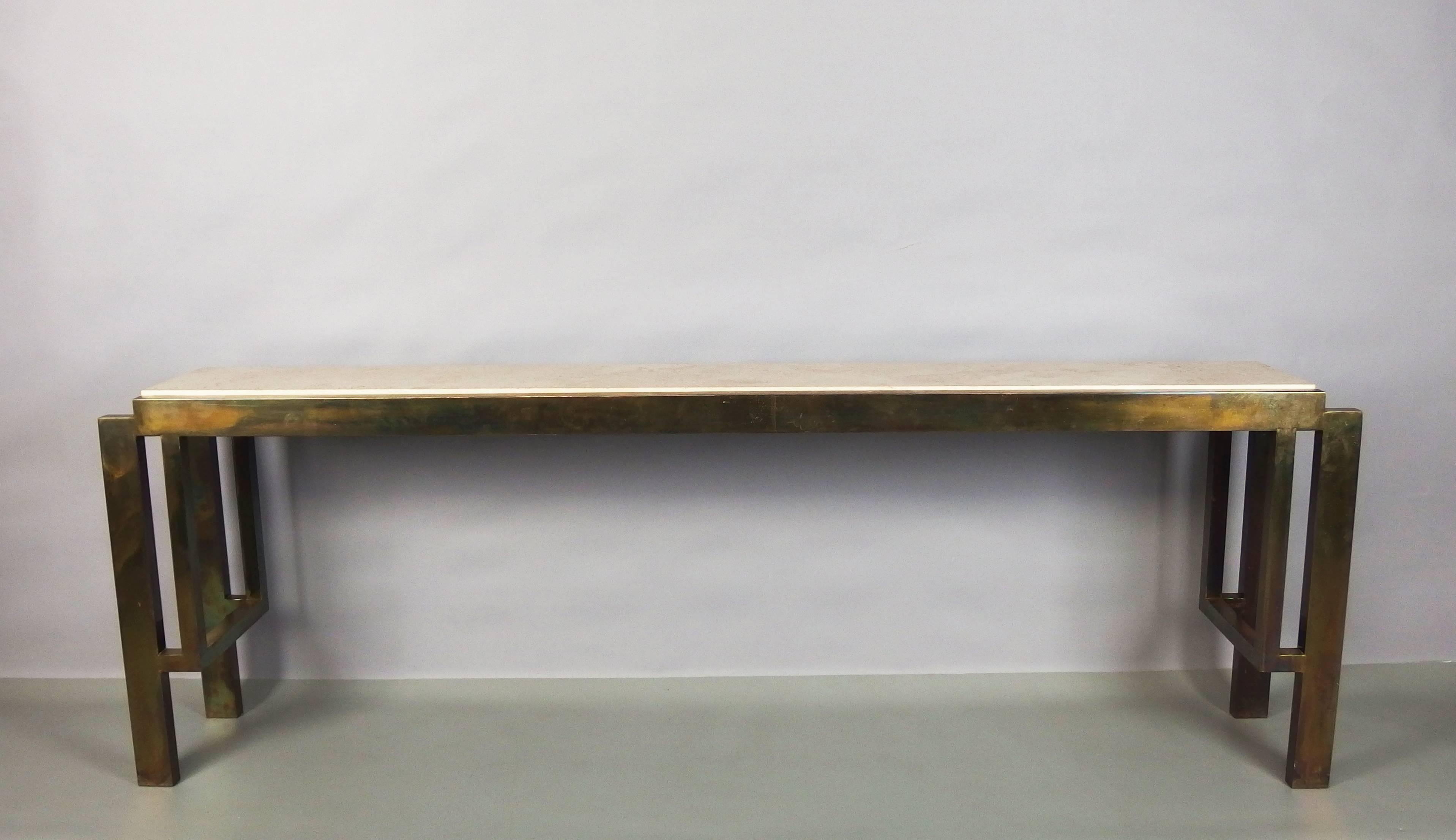 A patinated brass console table with a travertine top.