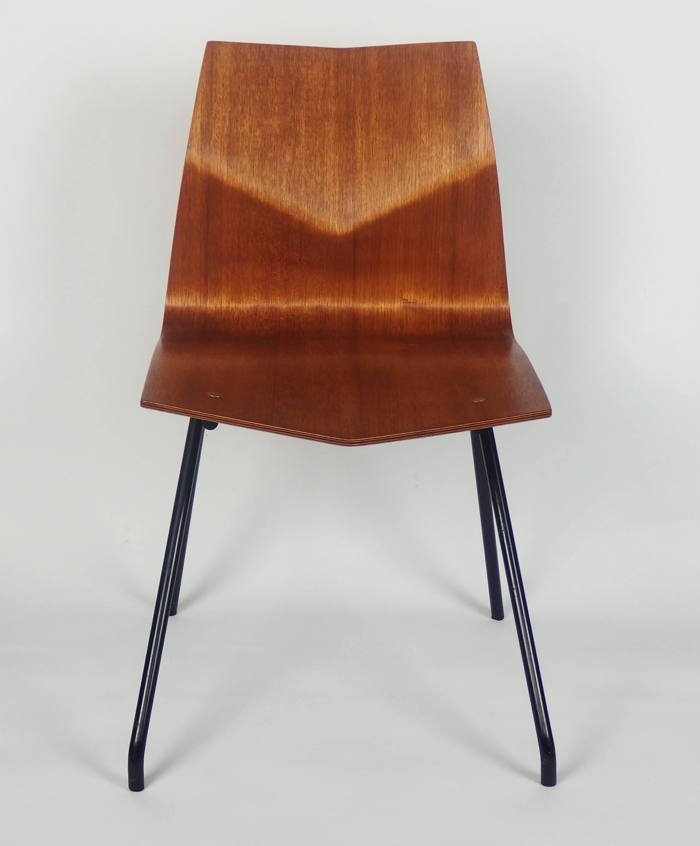 A plywood mahogany veneered chair with black enameled tubular metal feet.