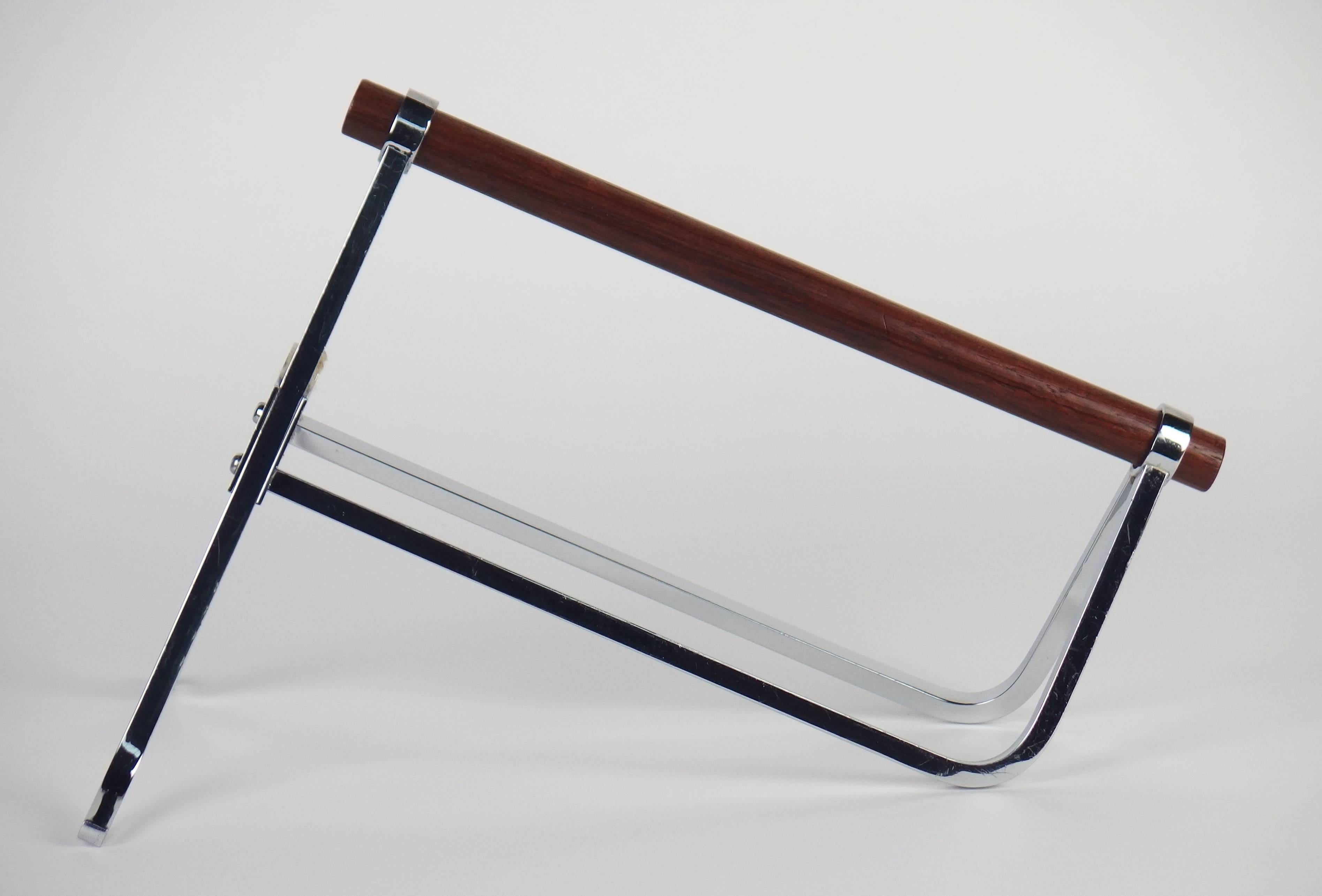 A chromed metal server with a mahogany handle. Modernist design by Jacques Adnet. Made in France mark on the bottom.
