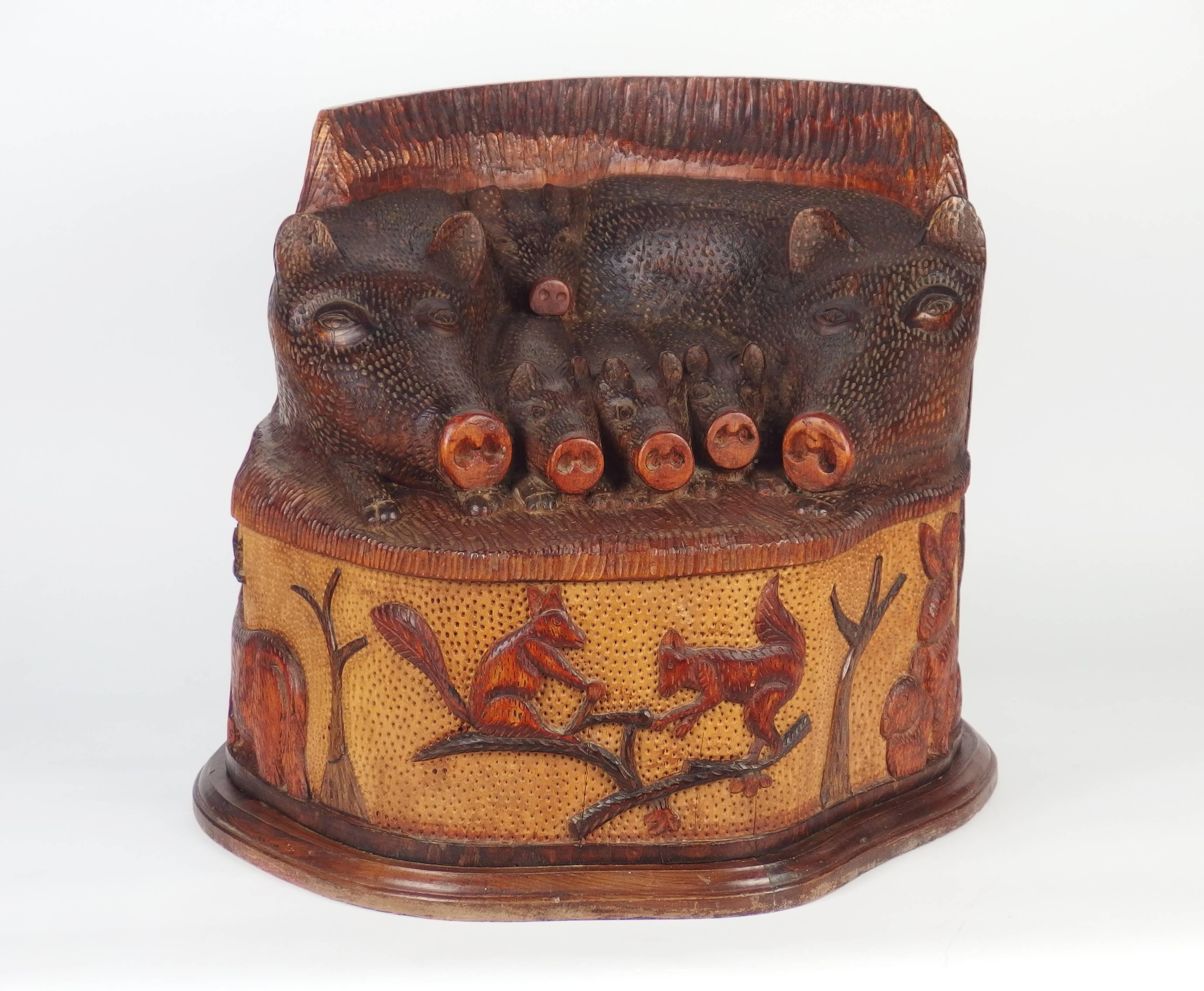 Folk Art stool with a "boar" family sculpted on the seat and a base decorated with squirrels, trees, rabbits and stag. Carved and stained wood.