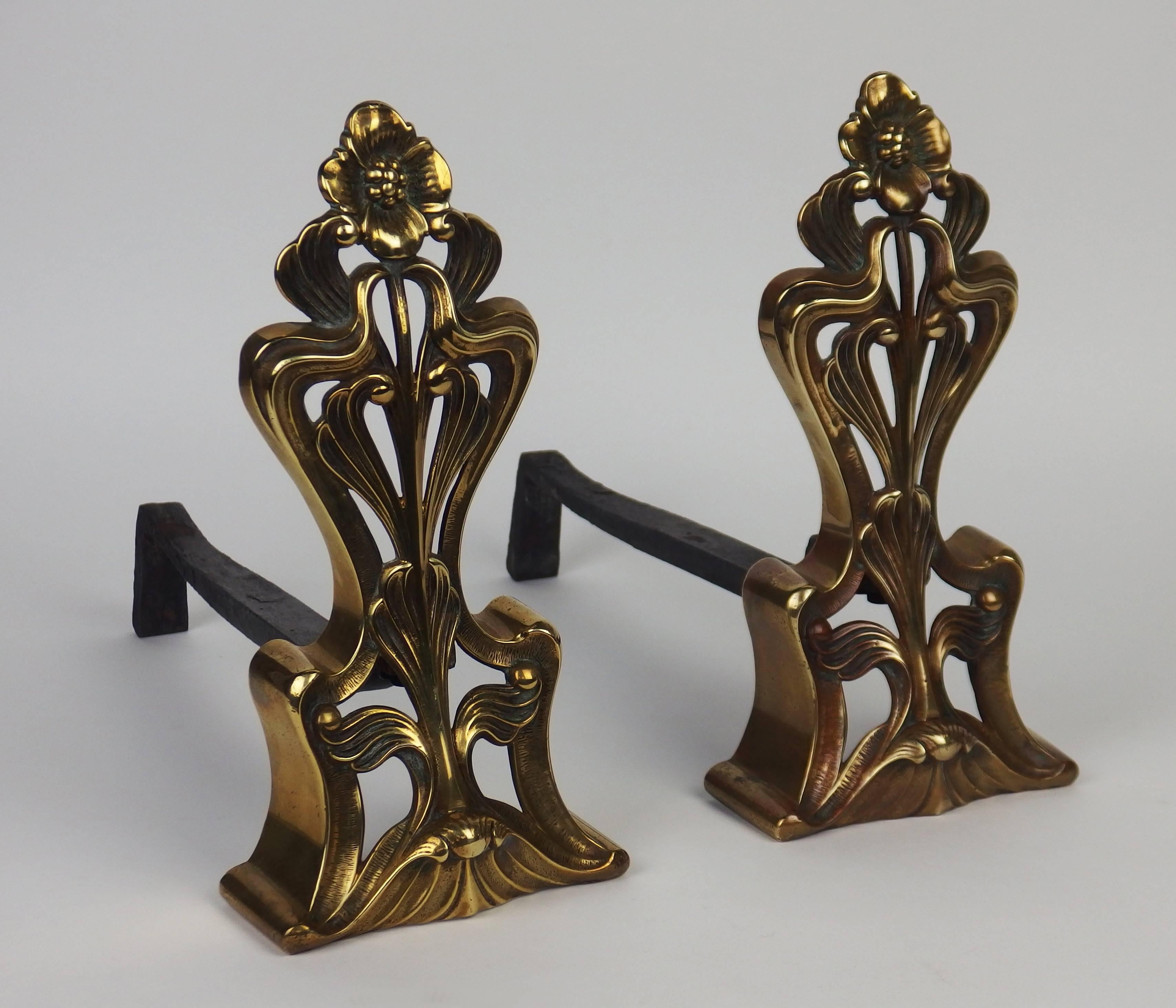 A pair of bronze andirons with typical Art Nouveau wavy lines and flowers.