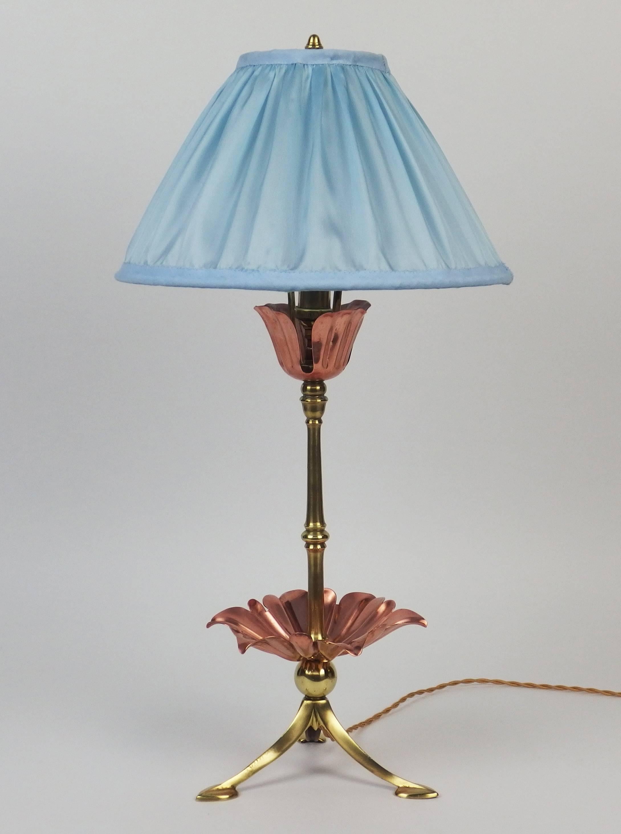 A brass table lamp with copper flowers decorations. New silk shade.
Unsigned.