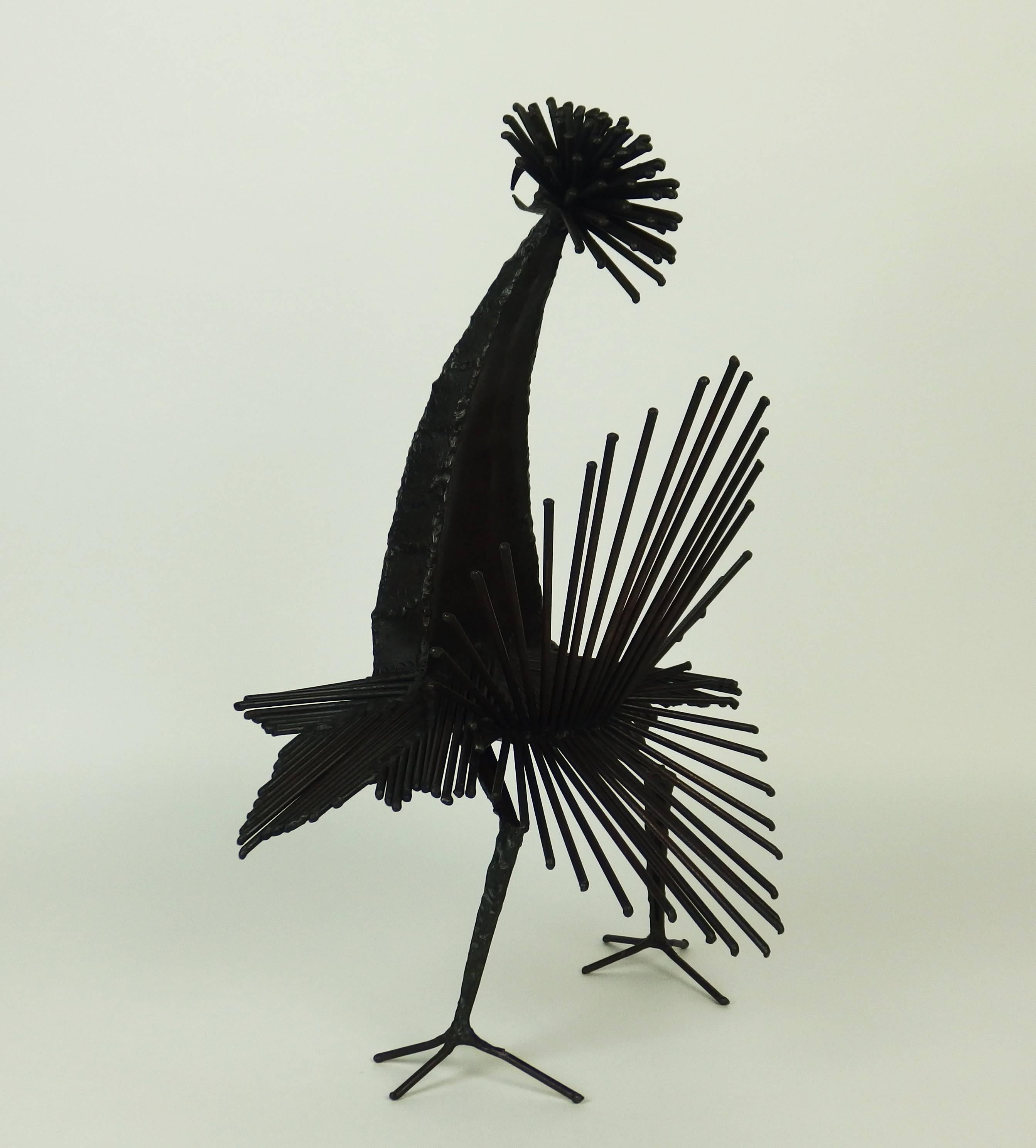 The rooster was created in the mid-1960s by the ceramist and sculptor Michel Anasse. This sculpture, made with patinated welded iron rods and hammered metal sheets, is representative of the use of metal in Anasse sculpted works.