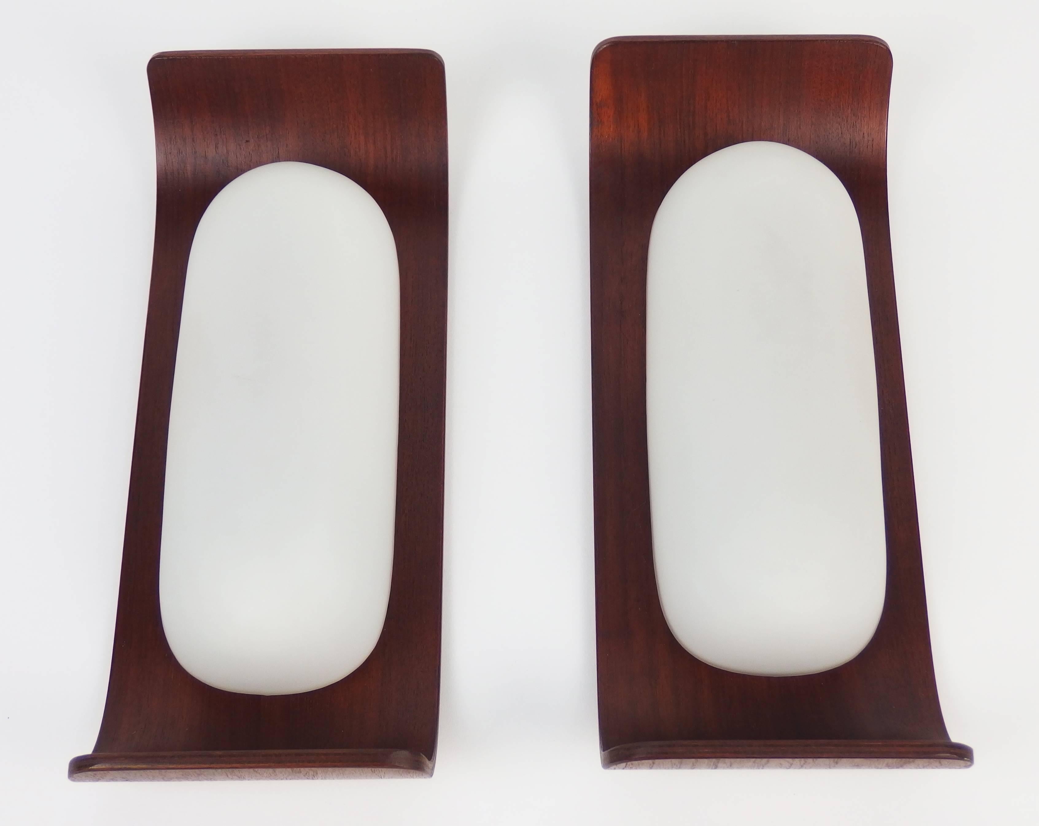 Two sconces with a bent teak wood support and white satin glass shades.