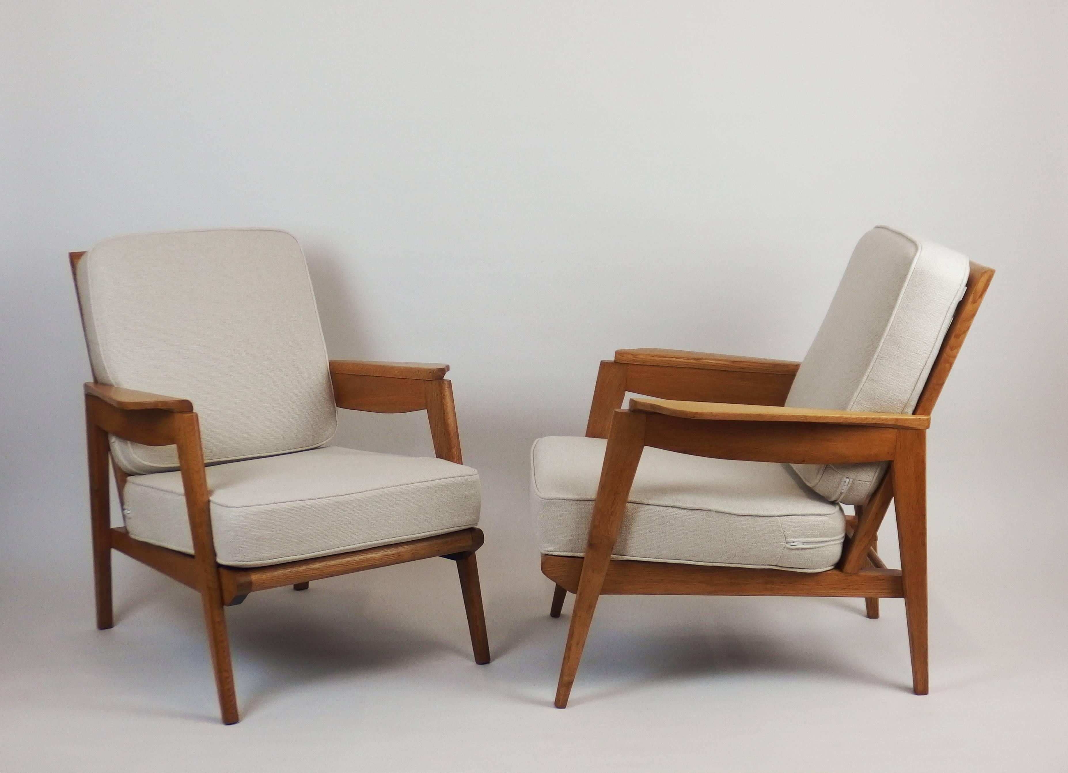 Two solid oak armchairs with new cushions upholstered with linen material .These armchairs were designed by Pierre Roche for the Parisian Ateliers Saint Sabin in the 1950s.
Measure: Seat height 15.30in.