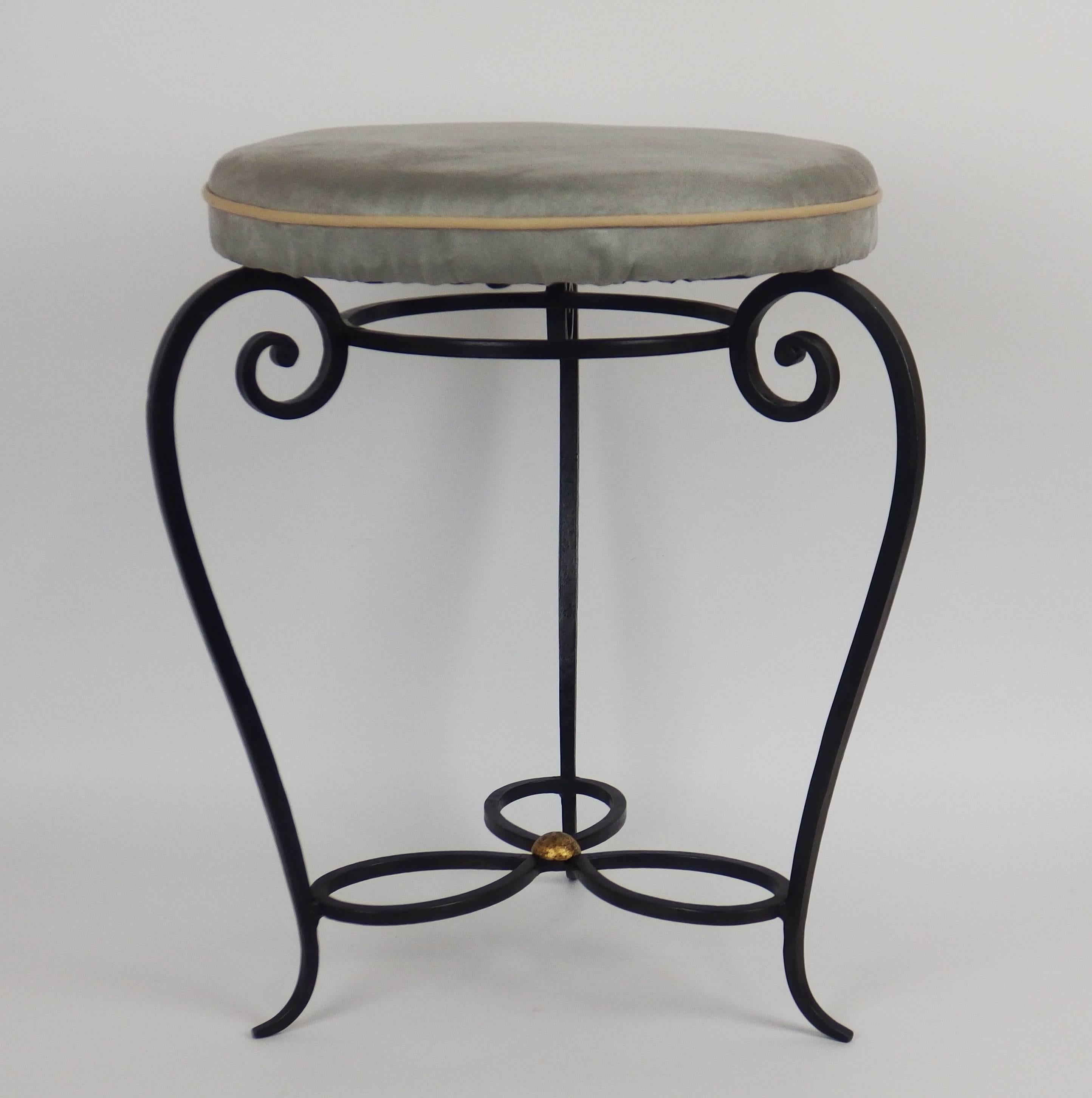 A 1940s wrought iron pair of stools with a black patina.