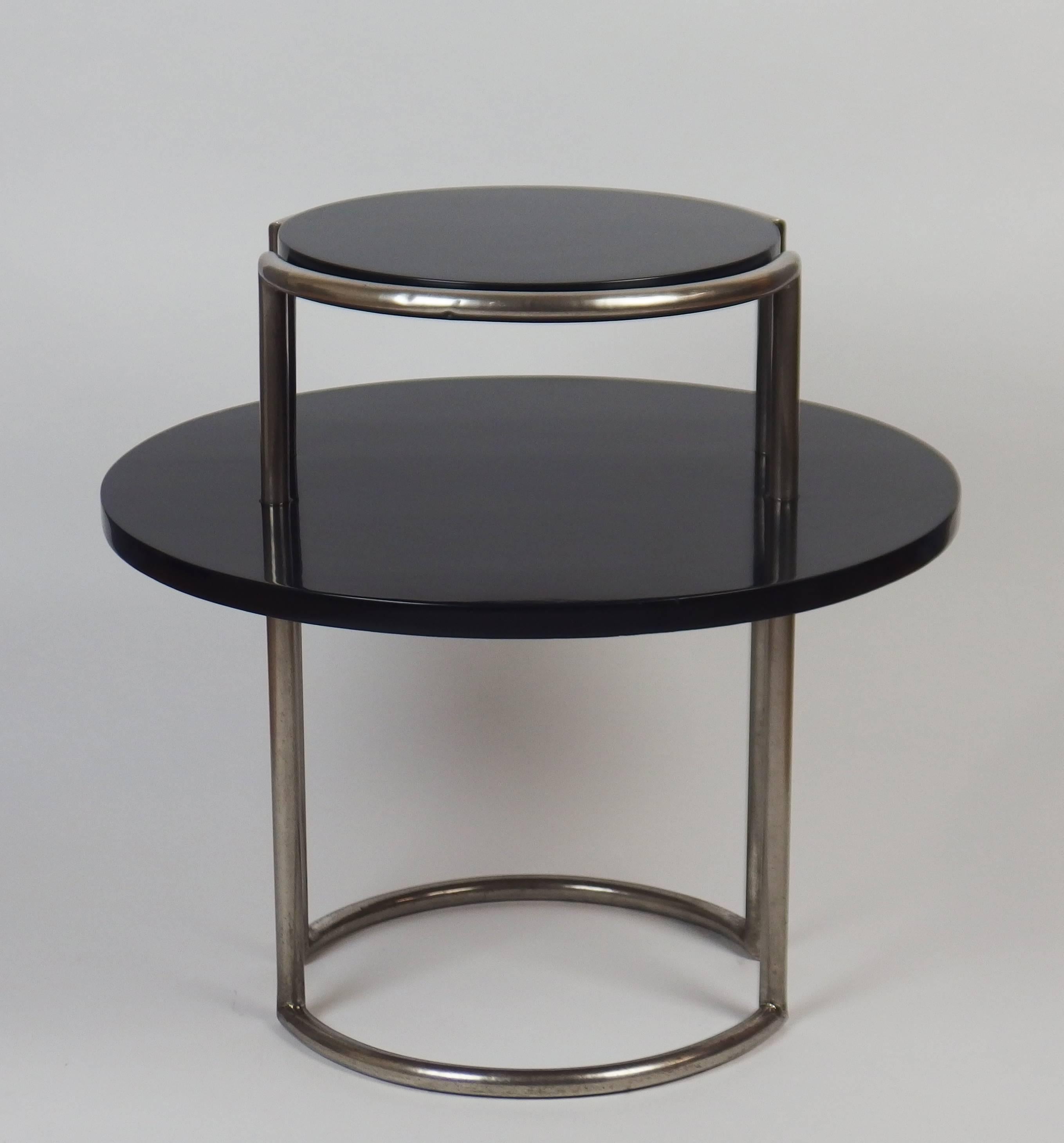 An Art Deco two-tier gueridon with black enameled mahogany shelves in a nickeled plated tubular structure. The surrounding metal structure is typical of Art Deco modernist creations of designers such as Louis Sognot or René Herbst.


  