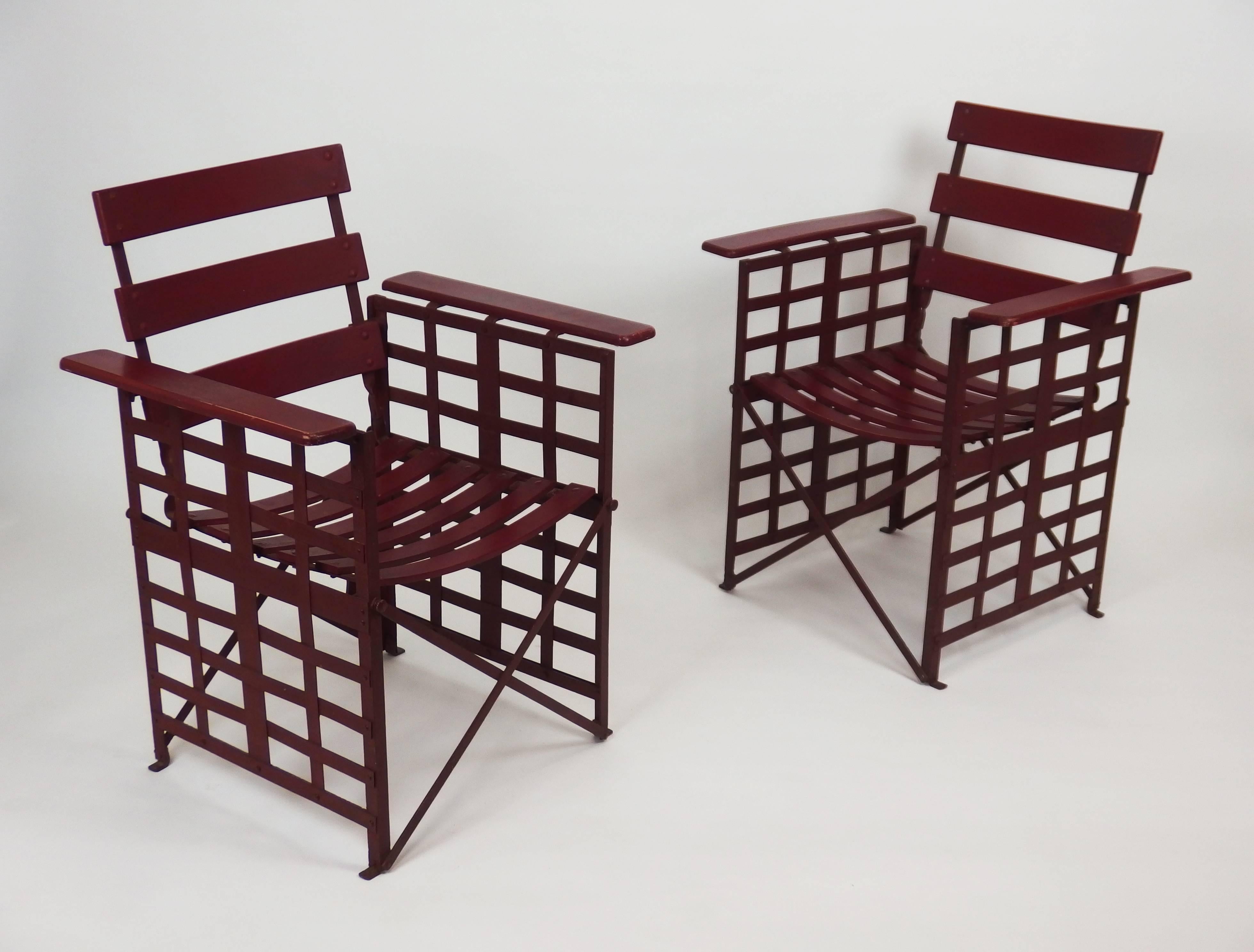 Two red enameled modernist style Art Deco folding garden armchairs with intertwined iron lames on both sides, and armrests, backs and seats made of plywood lames screwed on an iron structure.
Measures: Seats height 18.5 inches.