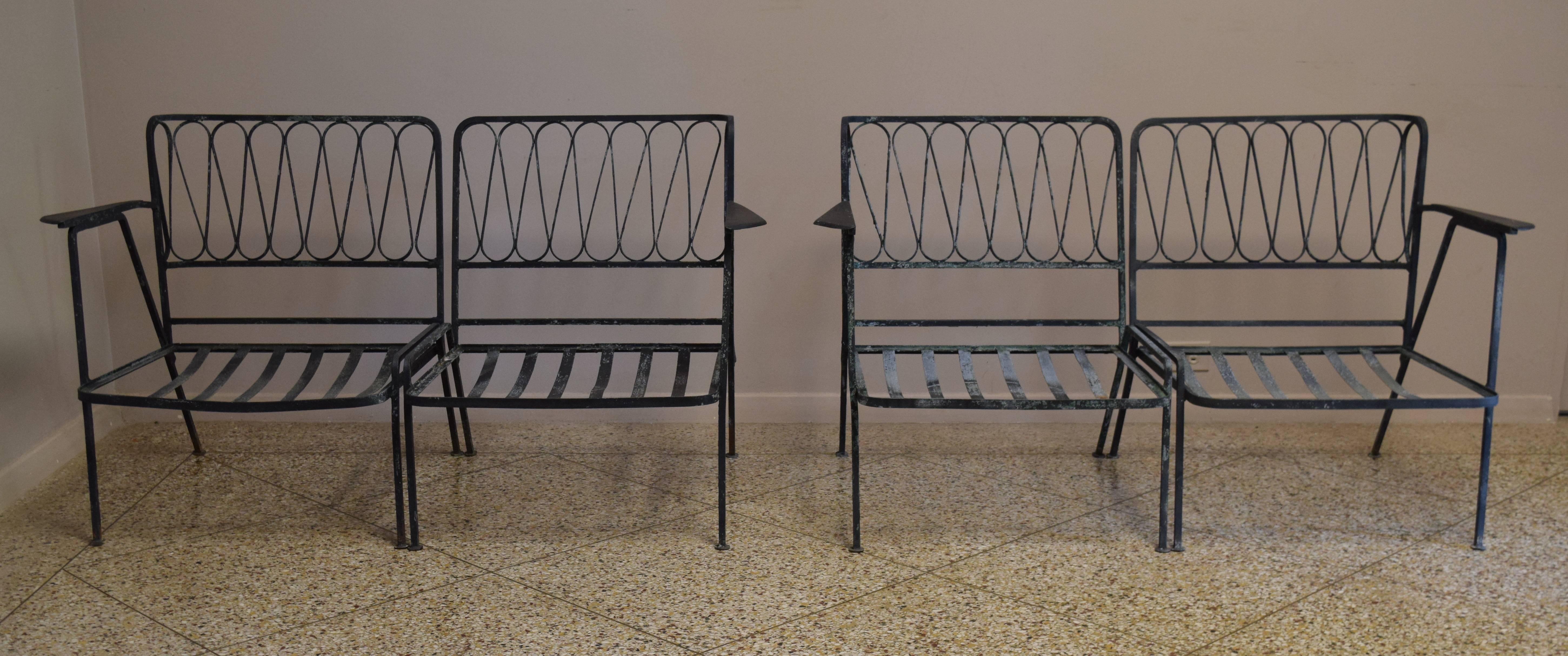 Beautiful pair of wrought iron loveseats from the famous ribbon line by Maurizio Tempestini for Salterini. Consists of four chairs altogether.

Matching table, wall mirror and headboard also available; please contact for details.