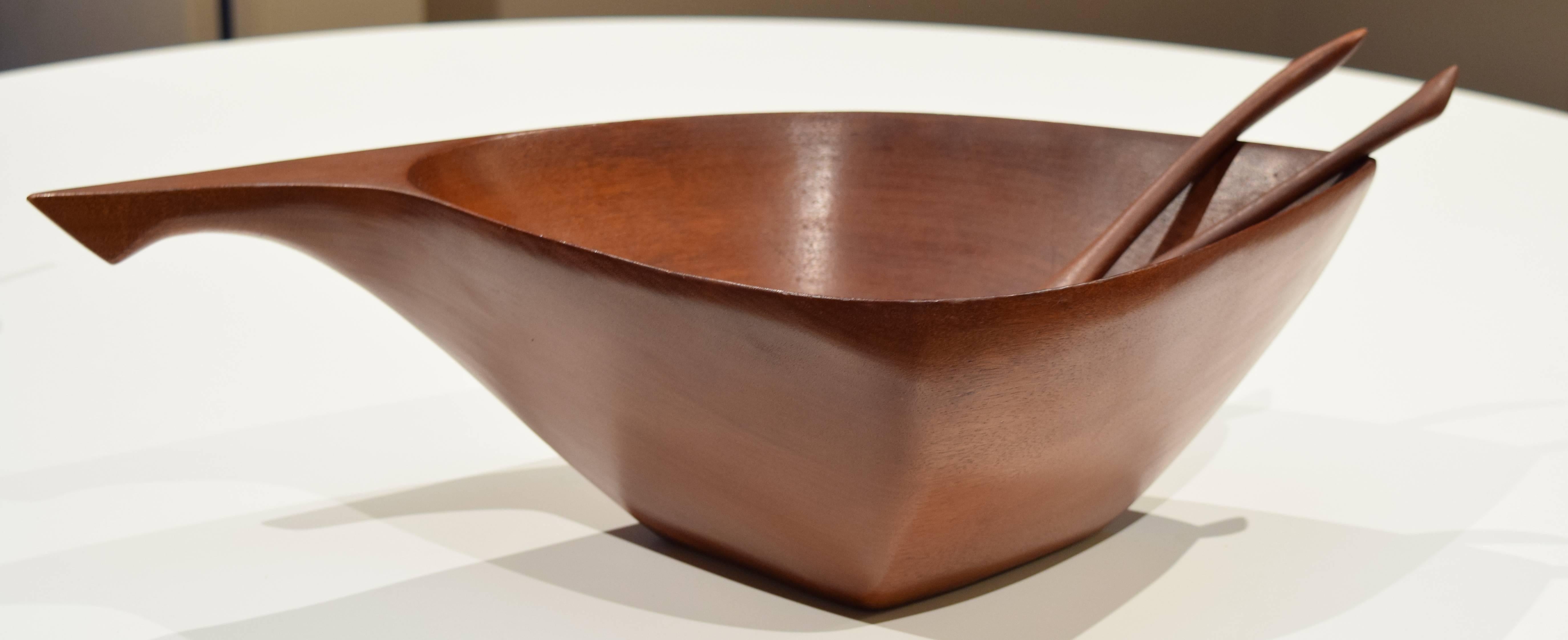 Sculptural bowl and serving utensils in solid mahogany. Made in Haiti by Arthur Umanoff and distributed by Raymor. Many other Umanoff items available including a 7-bottle wine rack, 12-bottle wine rack, two 67-bottle wine racks and two 39-bottle