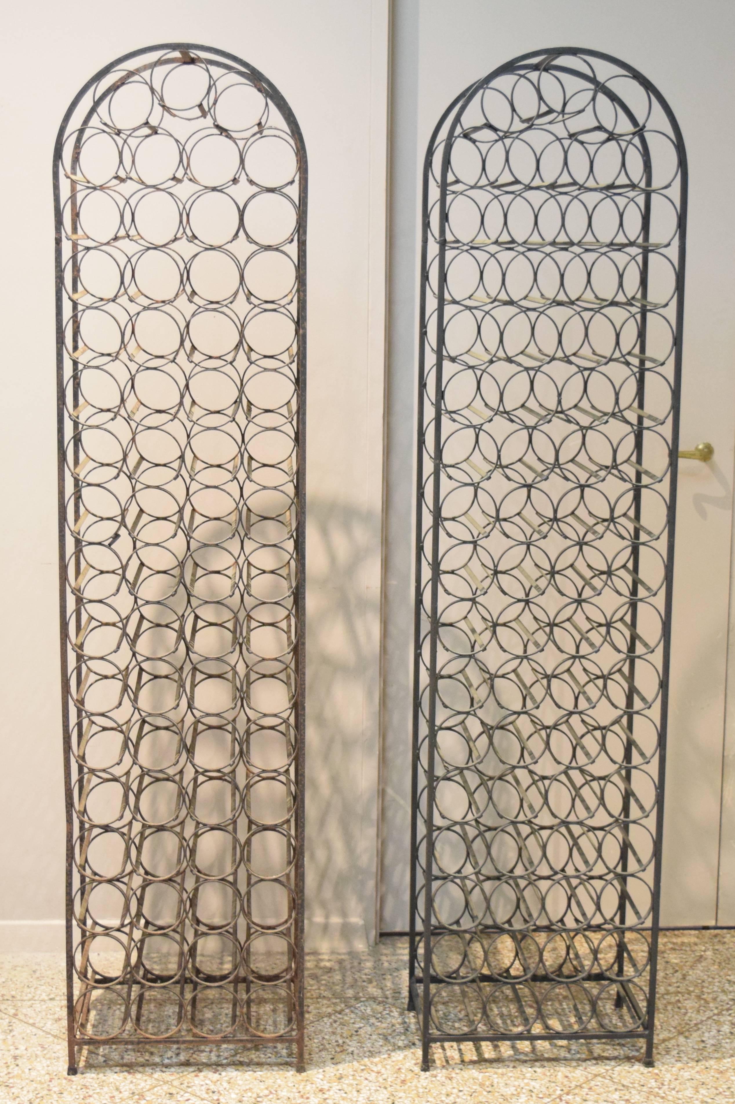 Two large wrought iron wine racks designed by Arthur Umanoff for Shaver Howard and distributed by Raymor. One has a fair amount of rust and will need to be sandblasted and powder coated, while the second is in better original condition. Many other