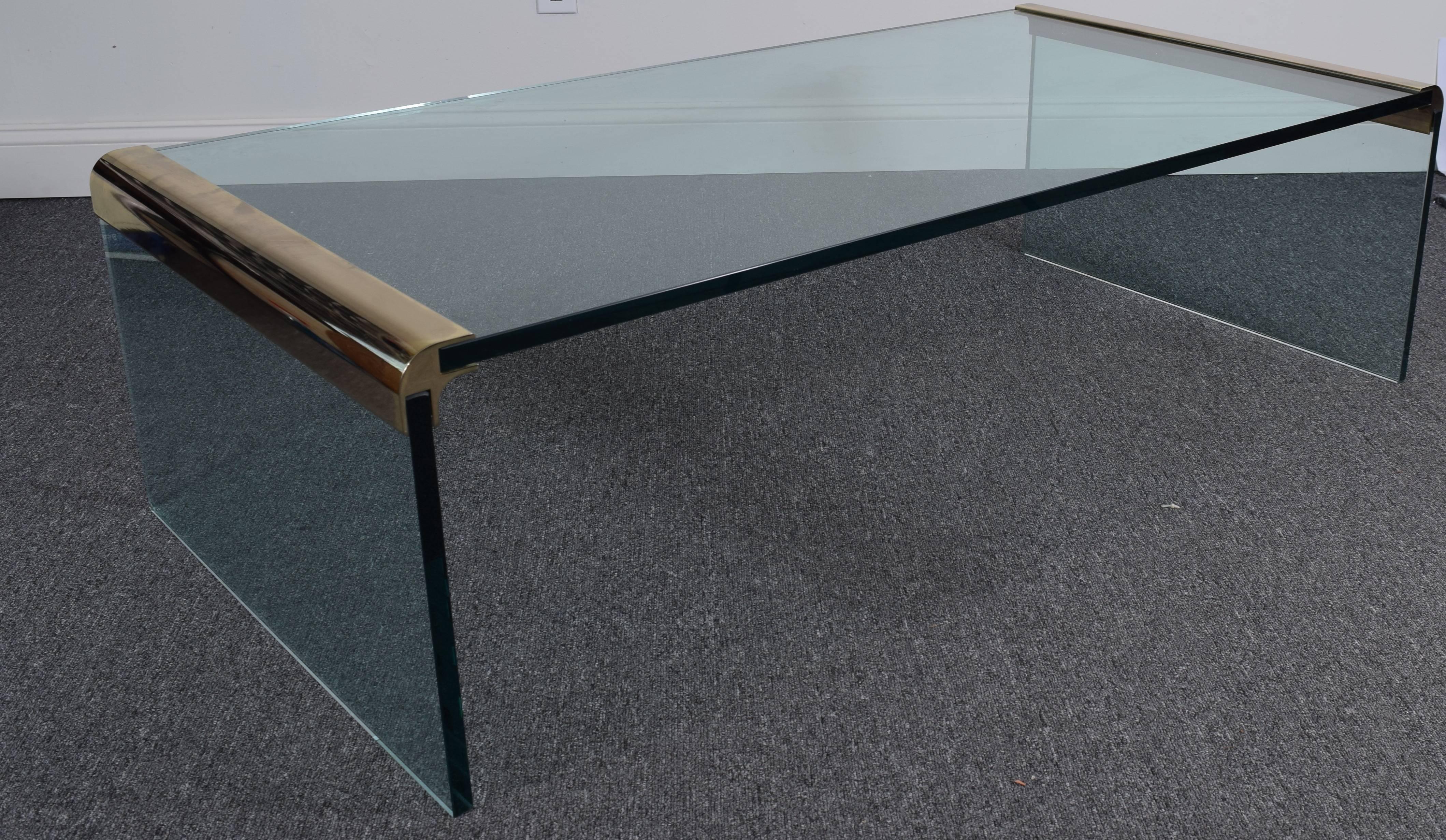 Store closing-- last day is 7/31. Offers welcome! Crisply tailored low table in thick, tinted glass with brass brackets. Signature Pace collection style in dramatic proportions. Exquisite.