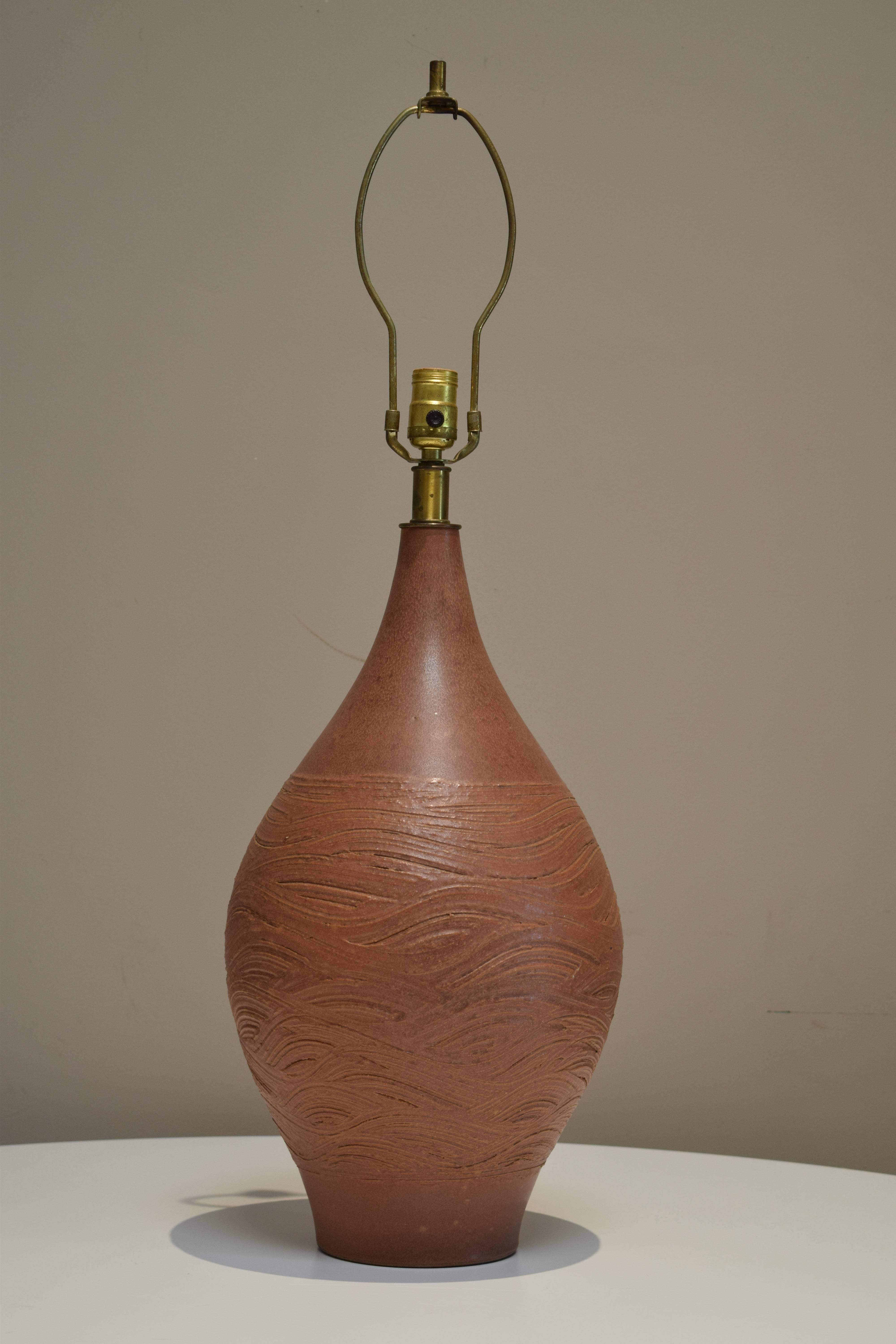 Hand-thrown ceramic lamp in a matte burnt sienna glaze with rich, textural detail. Exemplary design by Lee Rosen for Design Technics from the Series 3300. Signed with stamped medallion [DT] at base. Original custom burlap shade included. Please