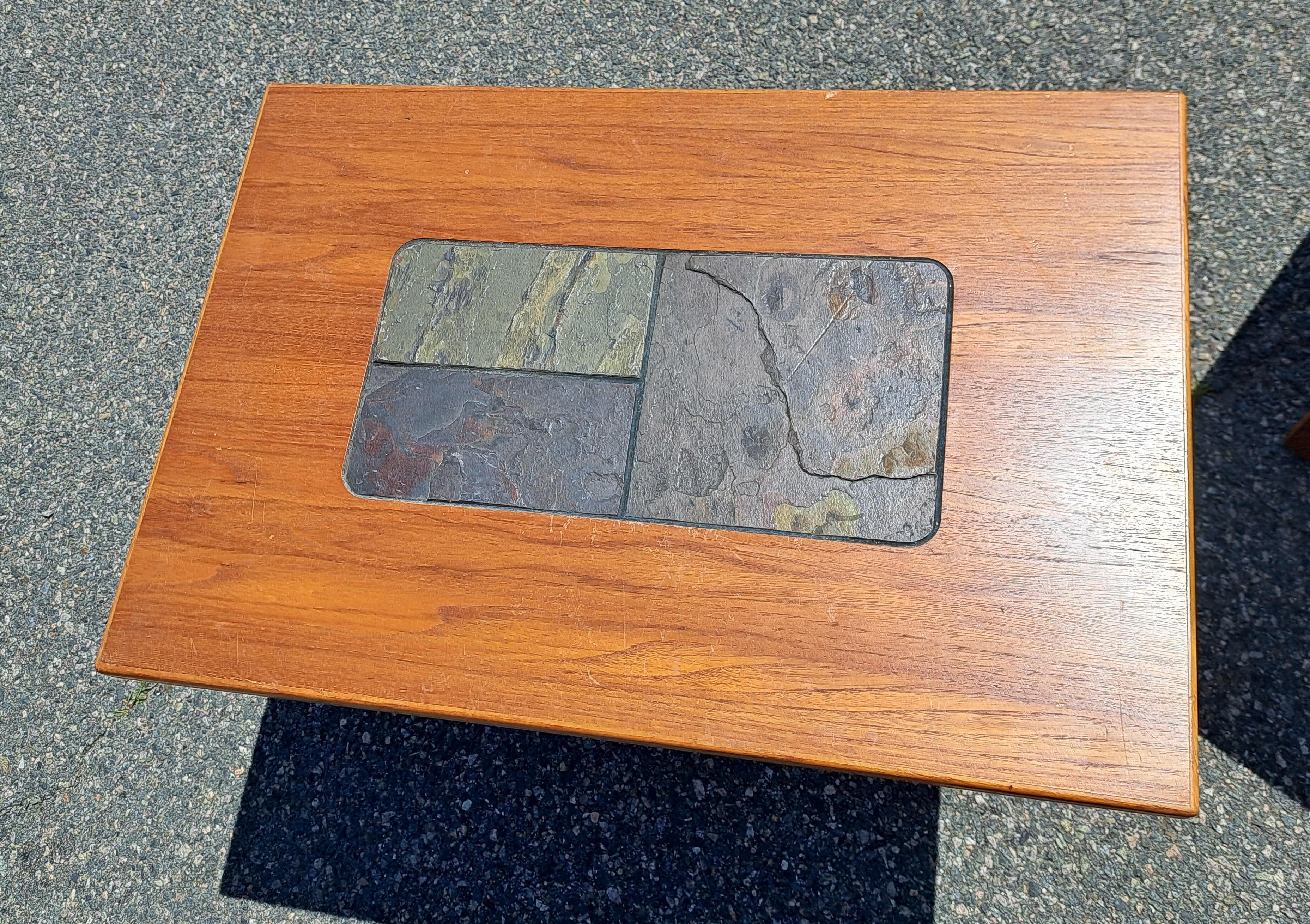 Pair of teak wood side tables with slate tile inlays on top. These Danish Modern tables are the perfect size for smaller  rooms or large dens.