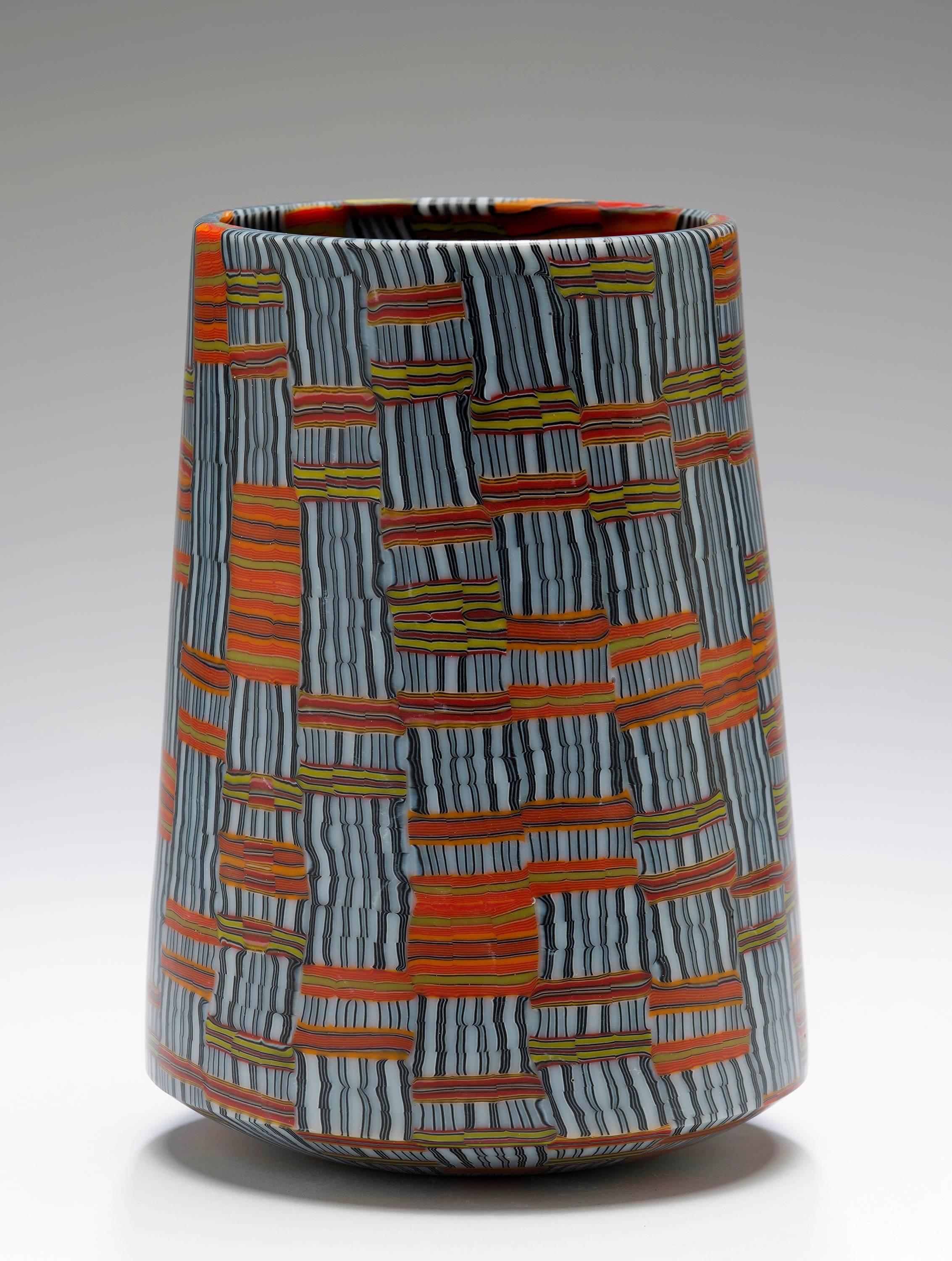 Textile 2014 is a glass vessel by glass artist Giles Bettison.

Giles Bettison is a master glass artist from Adelaide, SA, Australia. He has evolved the ancient Venetian technique called “Murrini” or mosaic glass to construct patterned sheets from