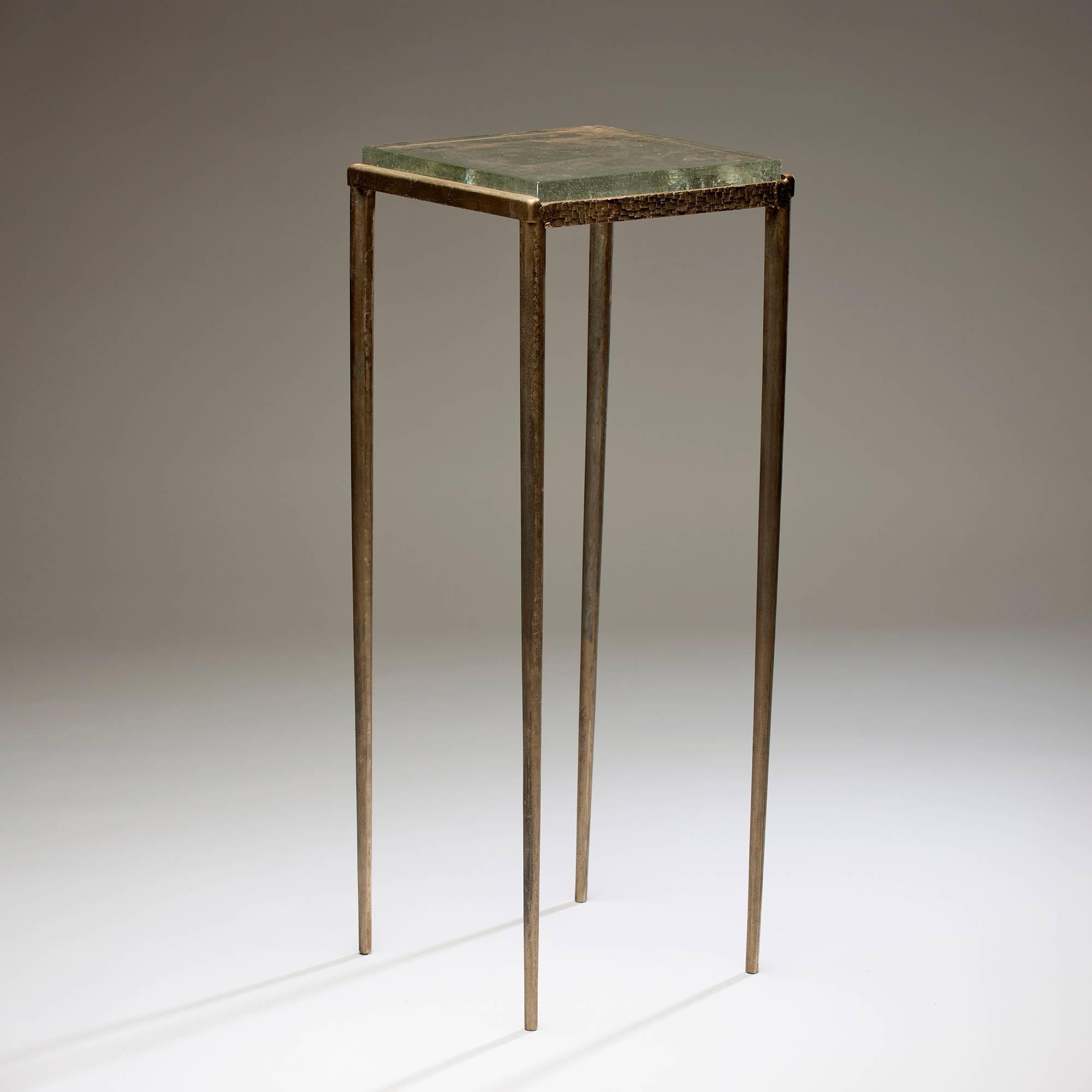 Gregory Nangle fabricated Ash Side Table out of cast bronze and glass; it is an edition of 6.

The Gregory Nangle aesthetic explores what happens when geometry is interjected into nature. His work juxtaposes Minimalist geometry with forms or