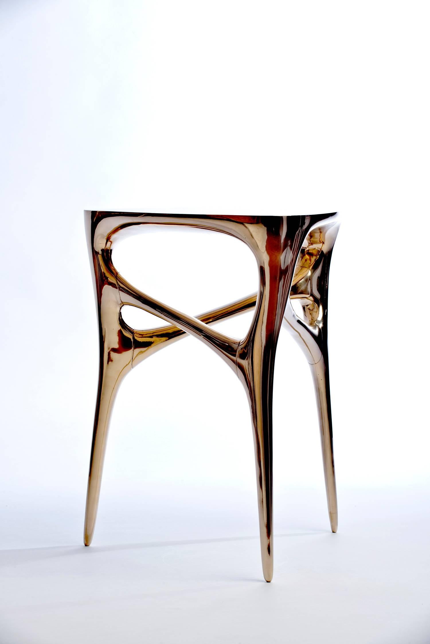 Exquisite cast and polished bronze side table by German artist and designer Timothy Schreiber.
Edition of 12

Timothy Schreiber initially trained in cabinet making in Germany before studying architecture and design in Germany and England, and has